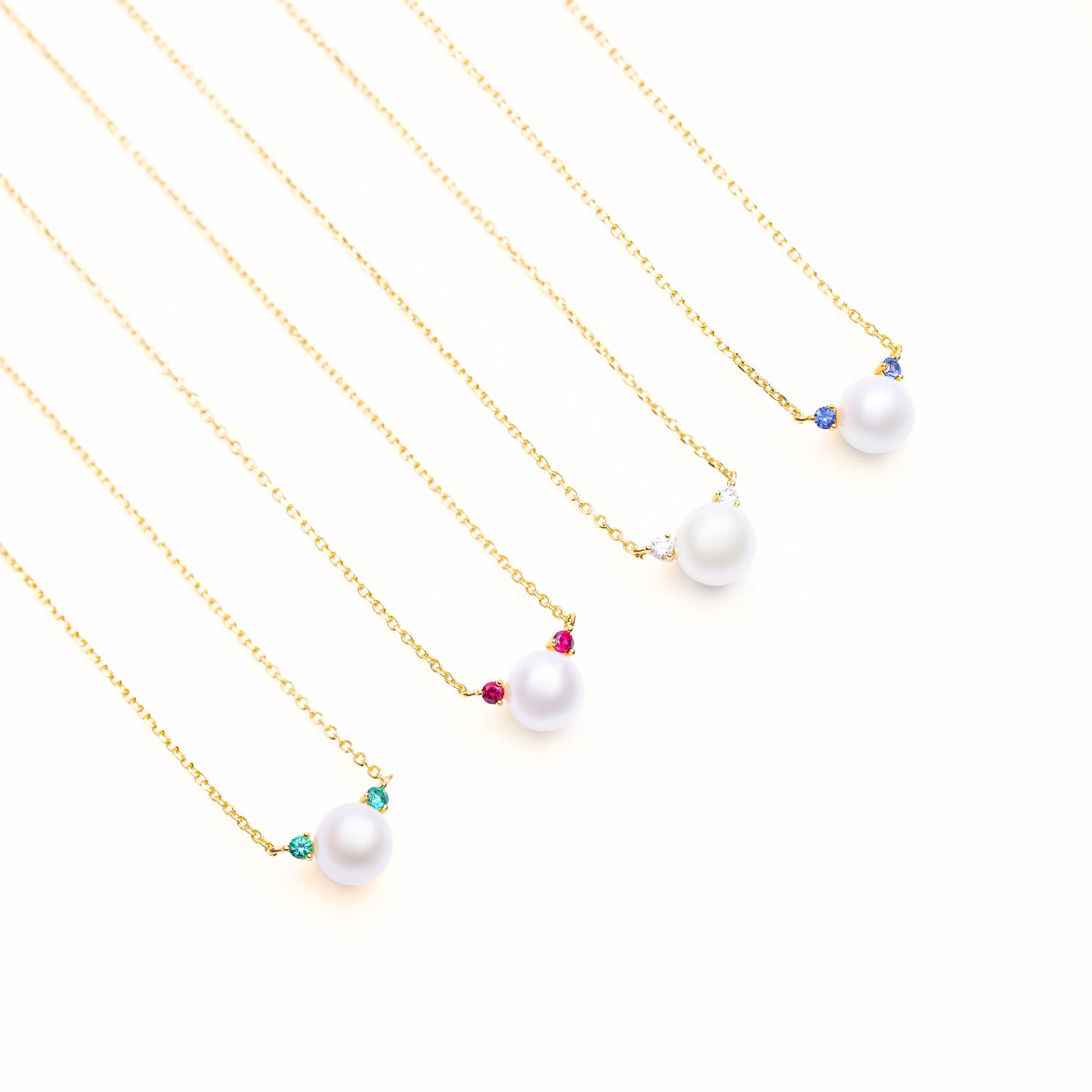 Accent Glow Necklace Collection with options of lab grown green emerald, red ruby, white diamond, or blue sapphire