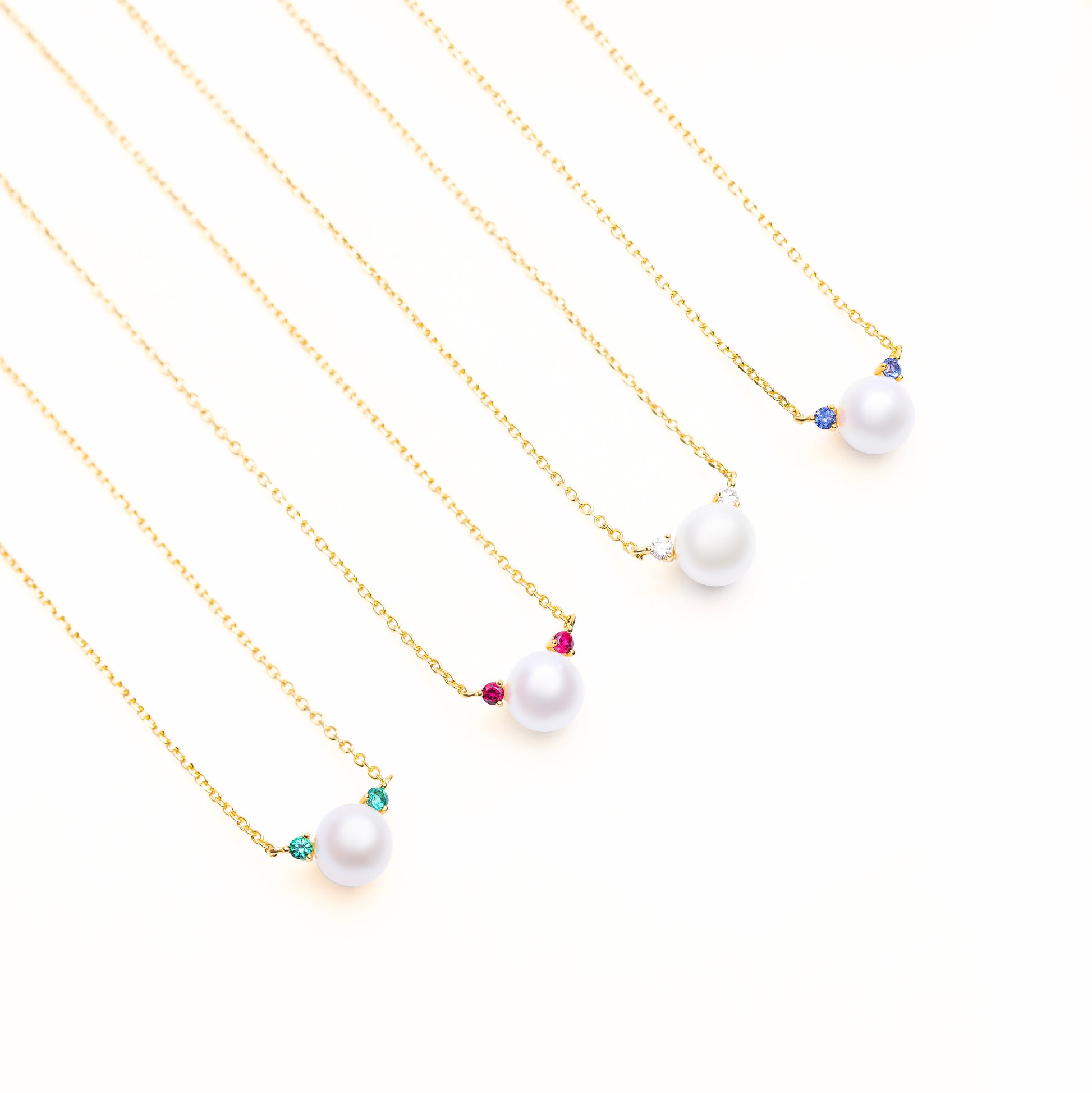 Accent Glow Necklace Collection with options of lab grown green emerald, red ruby, white diamond, or blue sapphire
