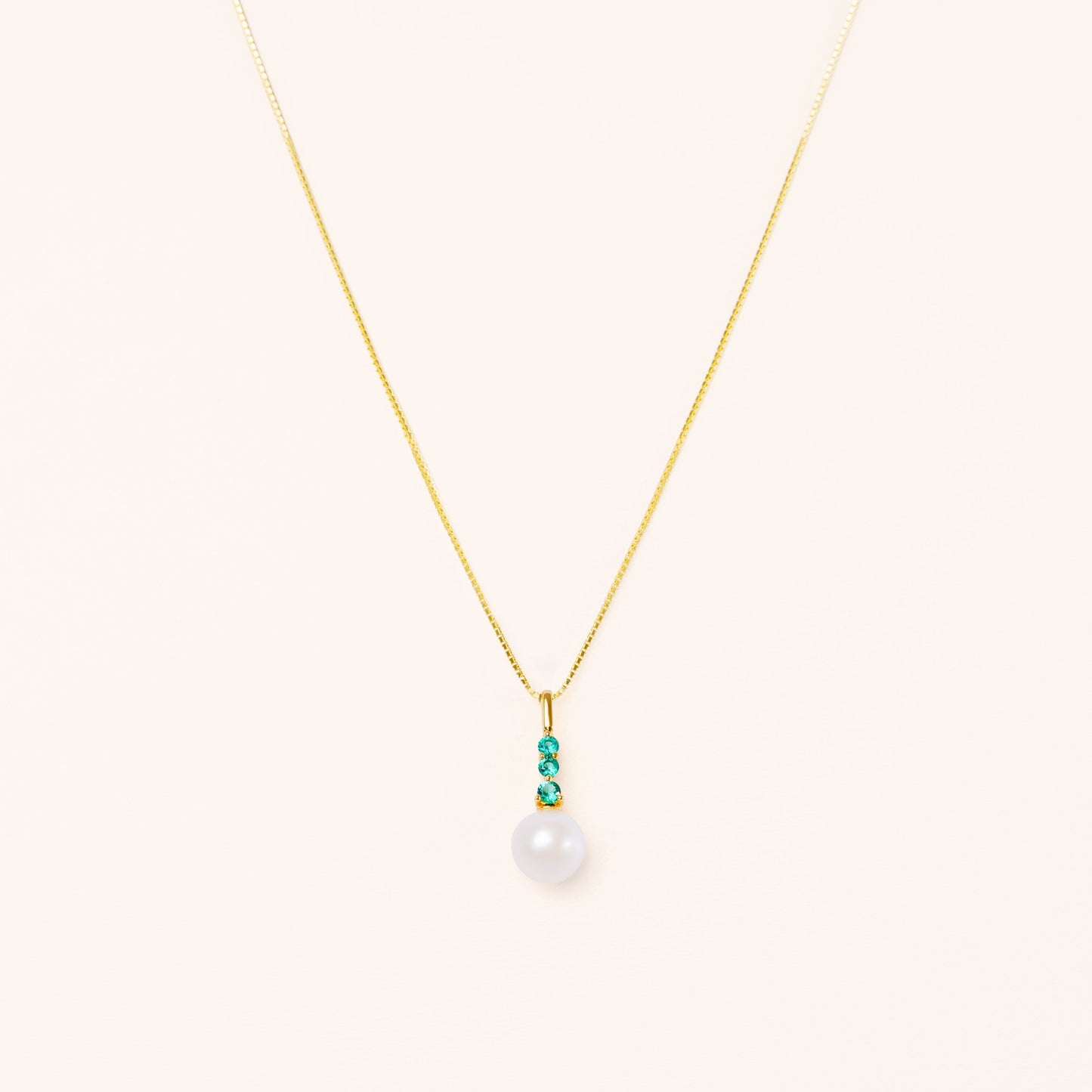 Pearl pendant with three beautiful emeralds. On a sleek adjustable gold chain
