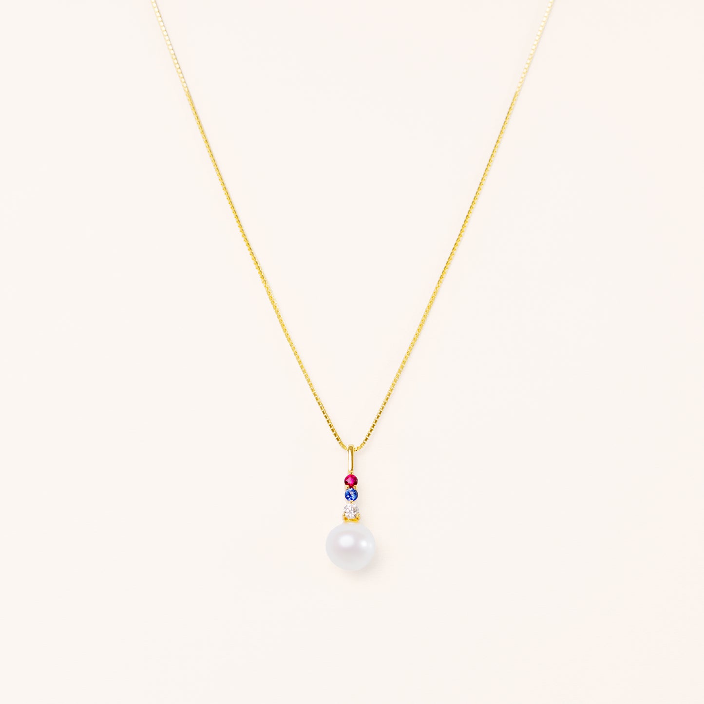 Pearl pendant with diamond, blue sapphire, and red ruby. American theme jewelry.