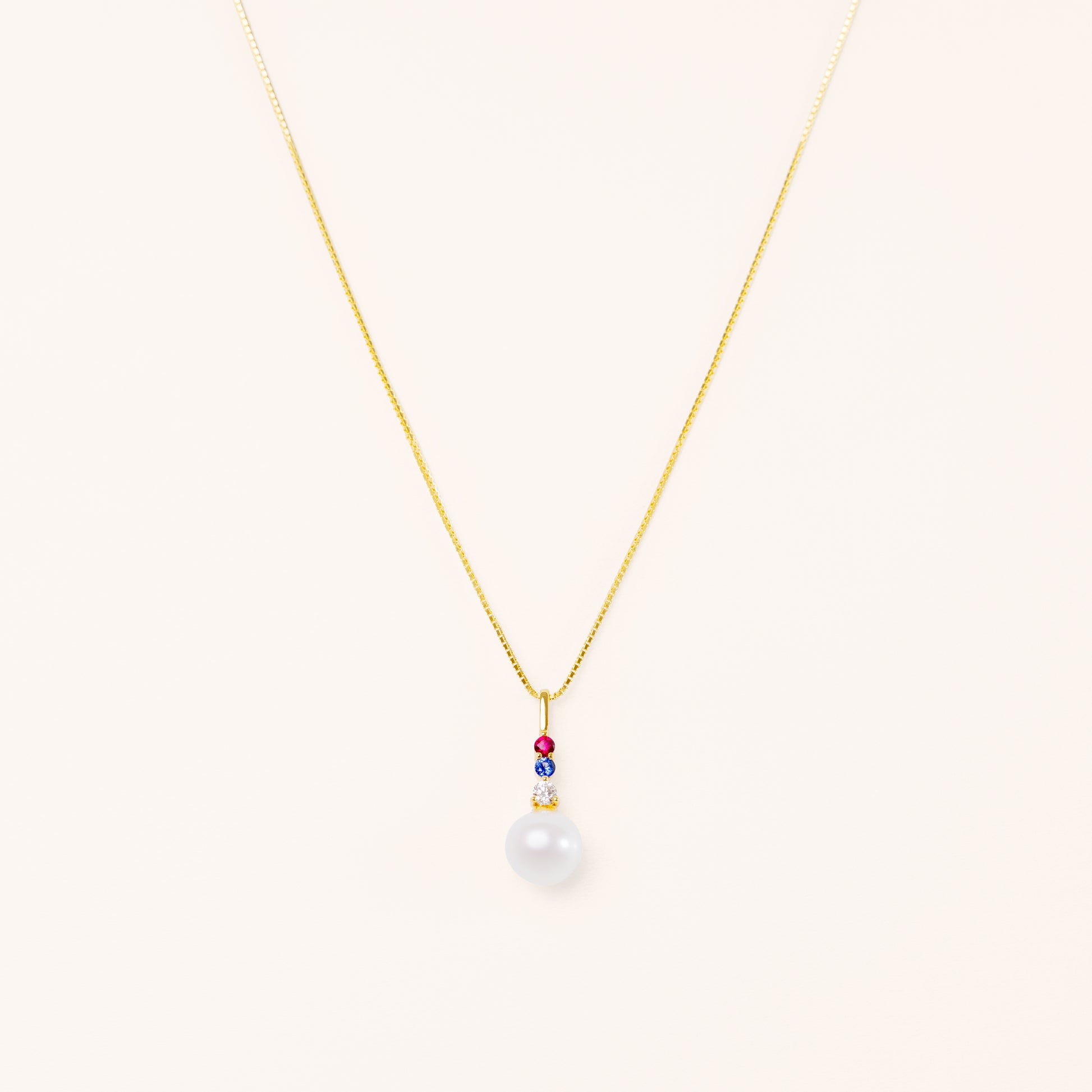 Pearl pendant with diamond, blue sapphire, and red ruby. American theme jewelry.