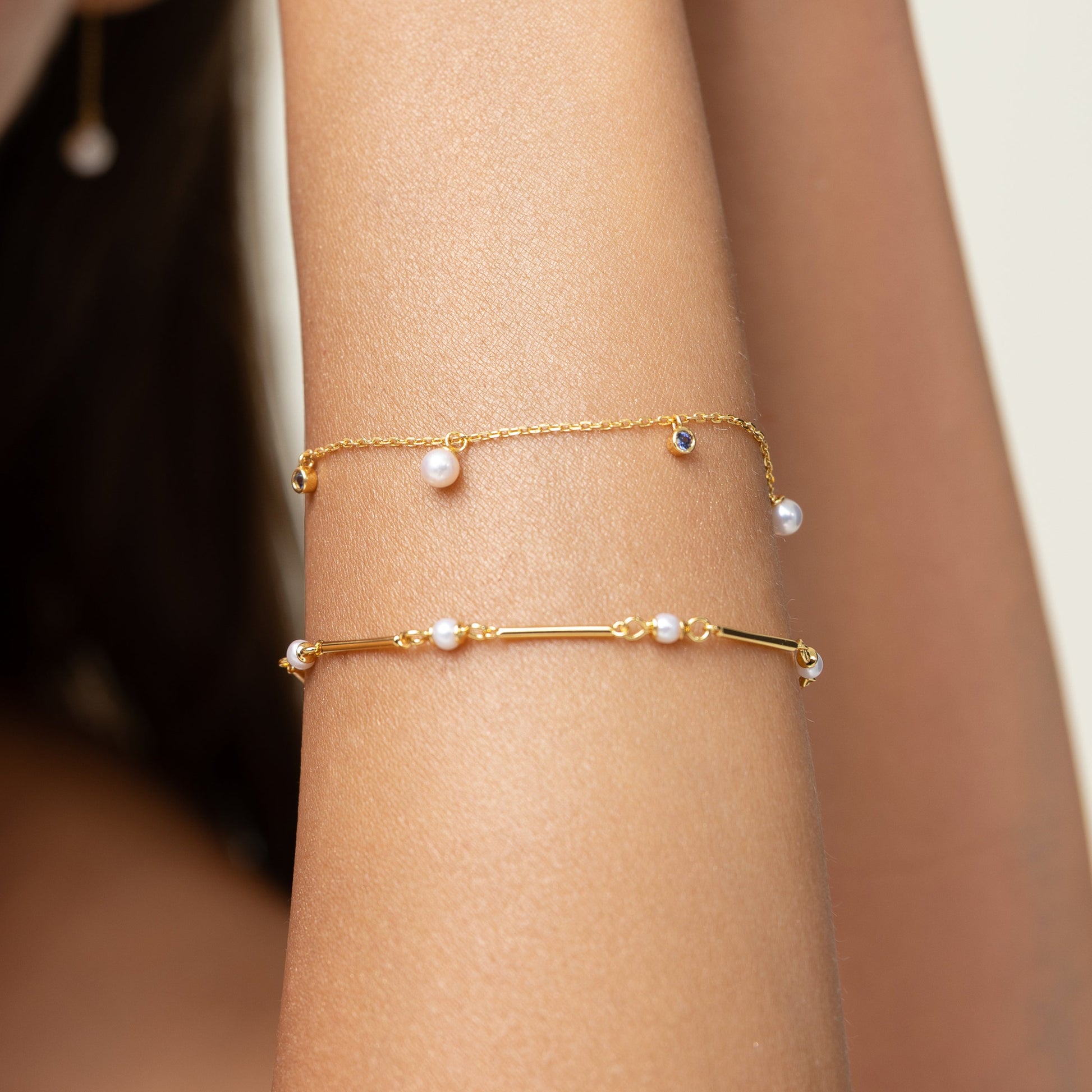 Pearl bracelet on a gold chain with dainty sapphire charms