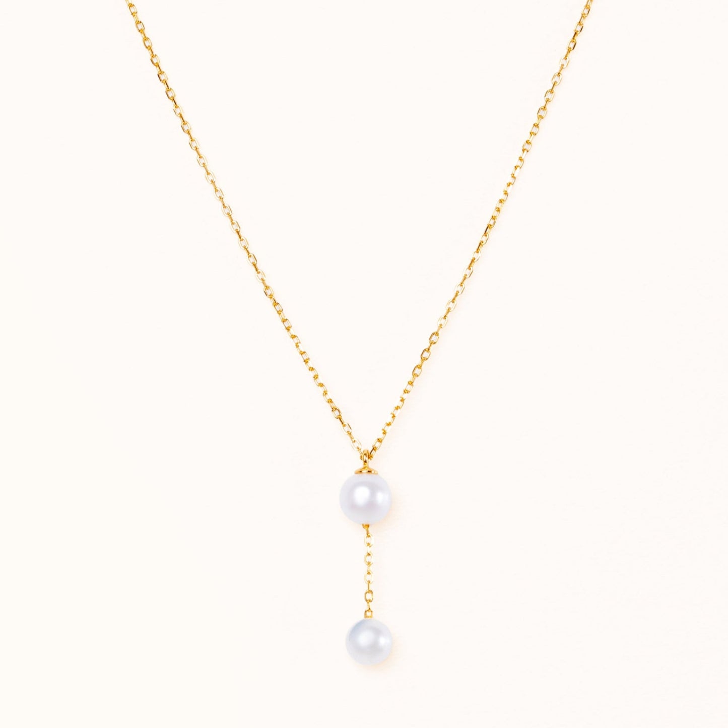 Necklace with a small pearl hanging from a large beautiful round pearl