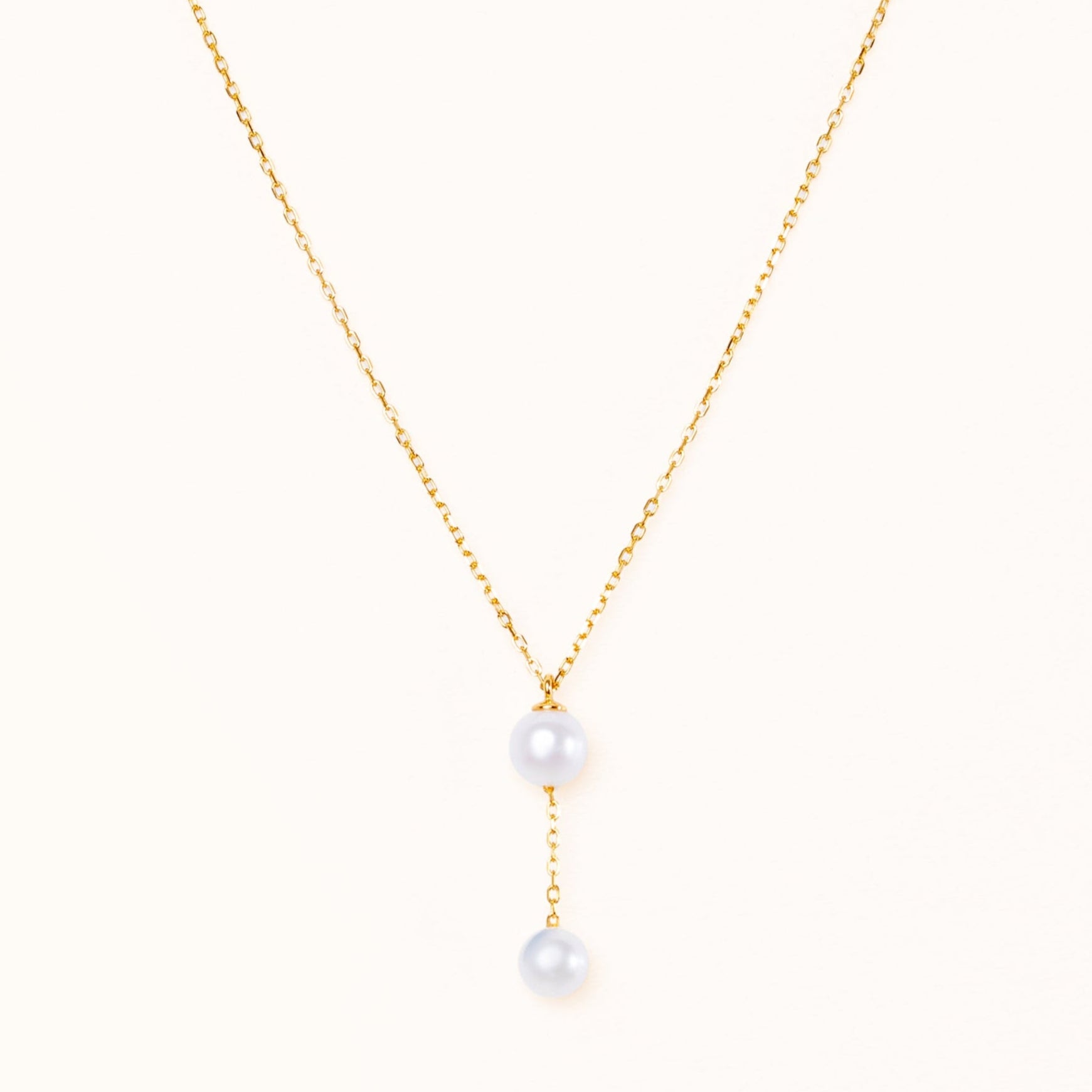 Necklace with a small pearl hanging from a large beautiful round pearl