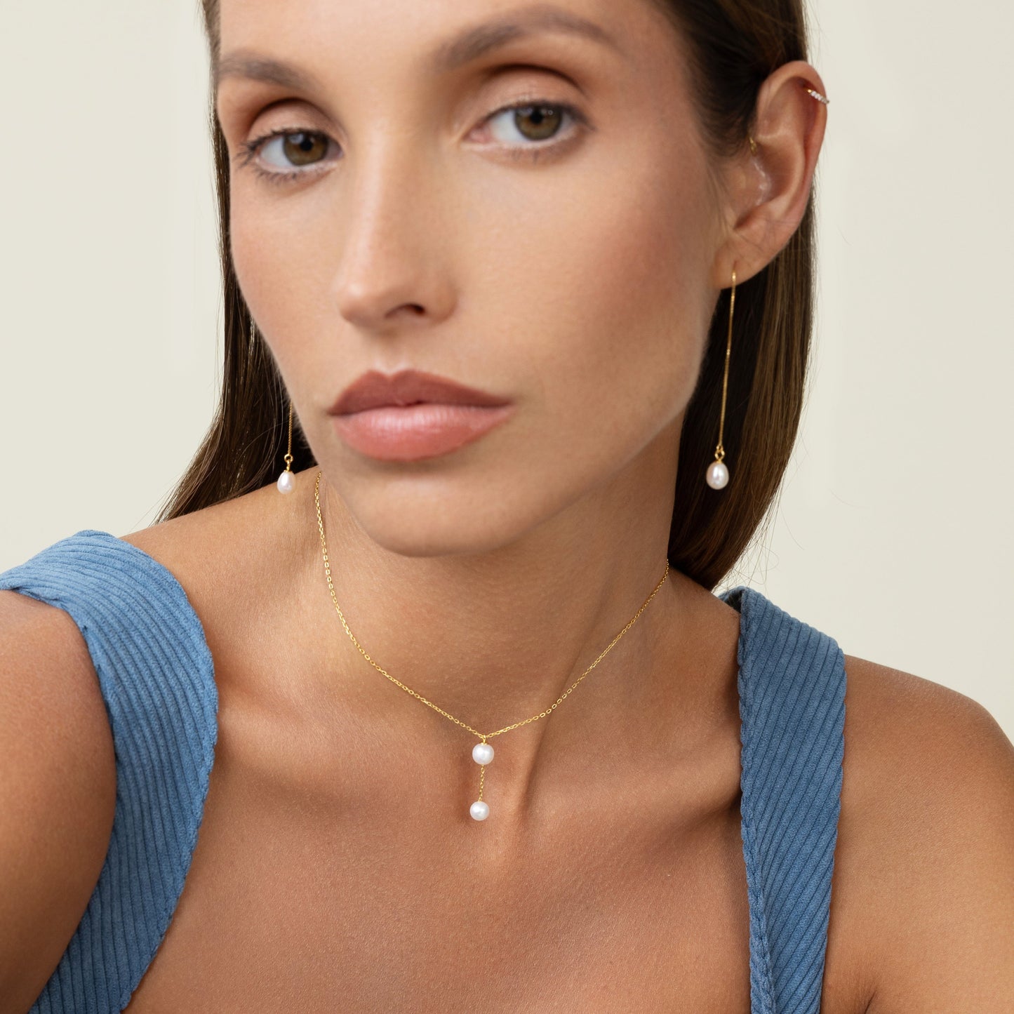 Large peal with a smaller pearl hanging by a gold chain. Simple and elegant. Wear it as a choker
