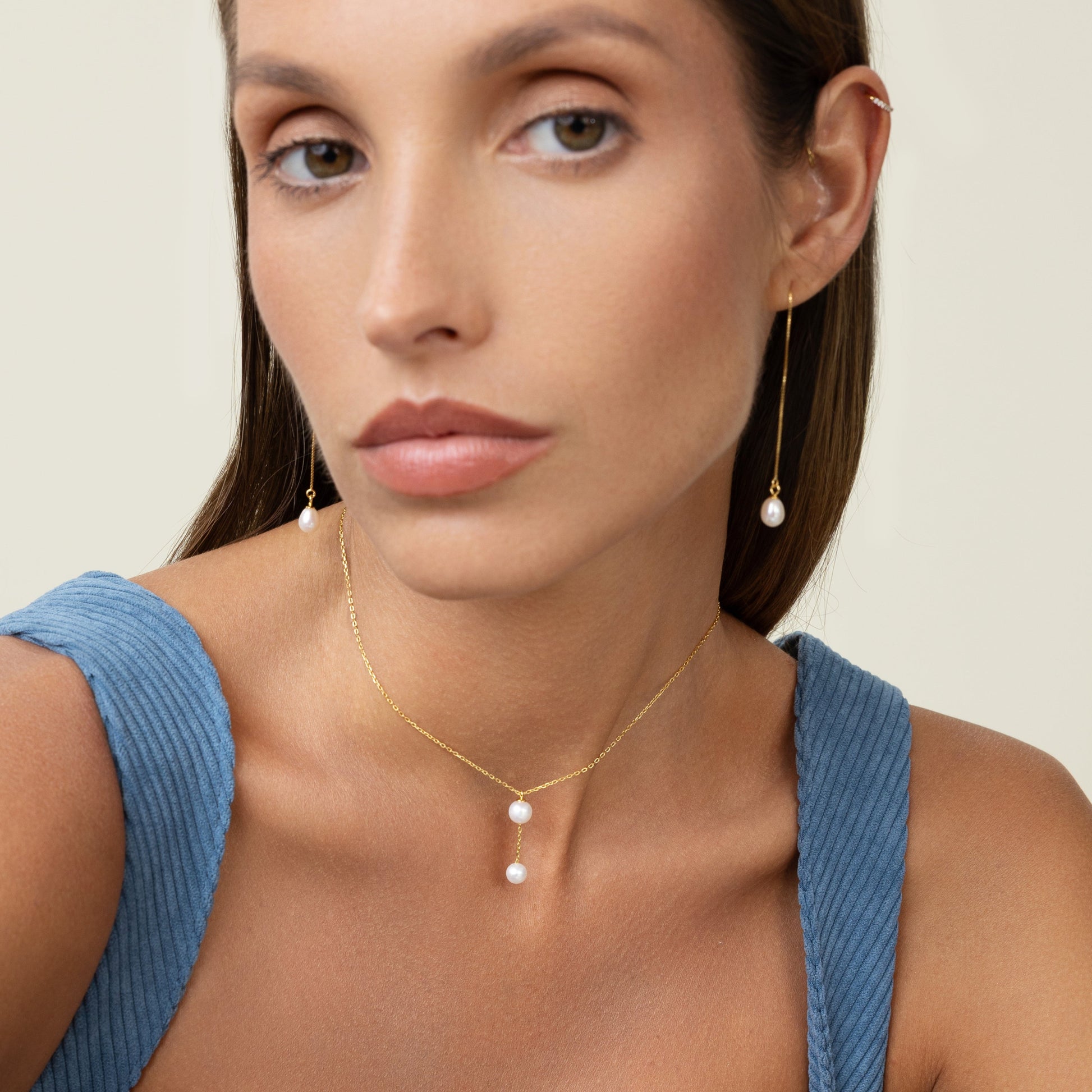Large peal with a smaller pearl hanging by a gold chain. Simple and elegant. Wear it as a choker