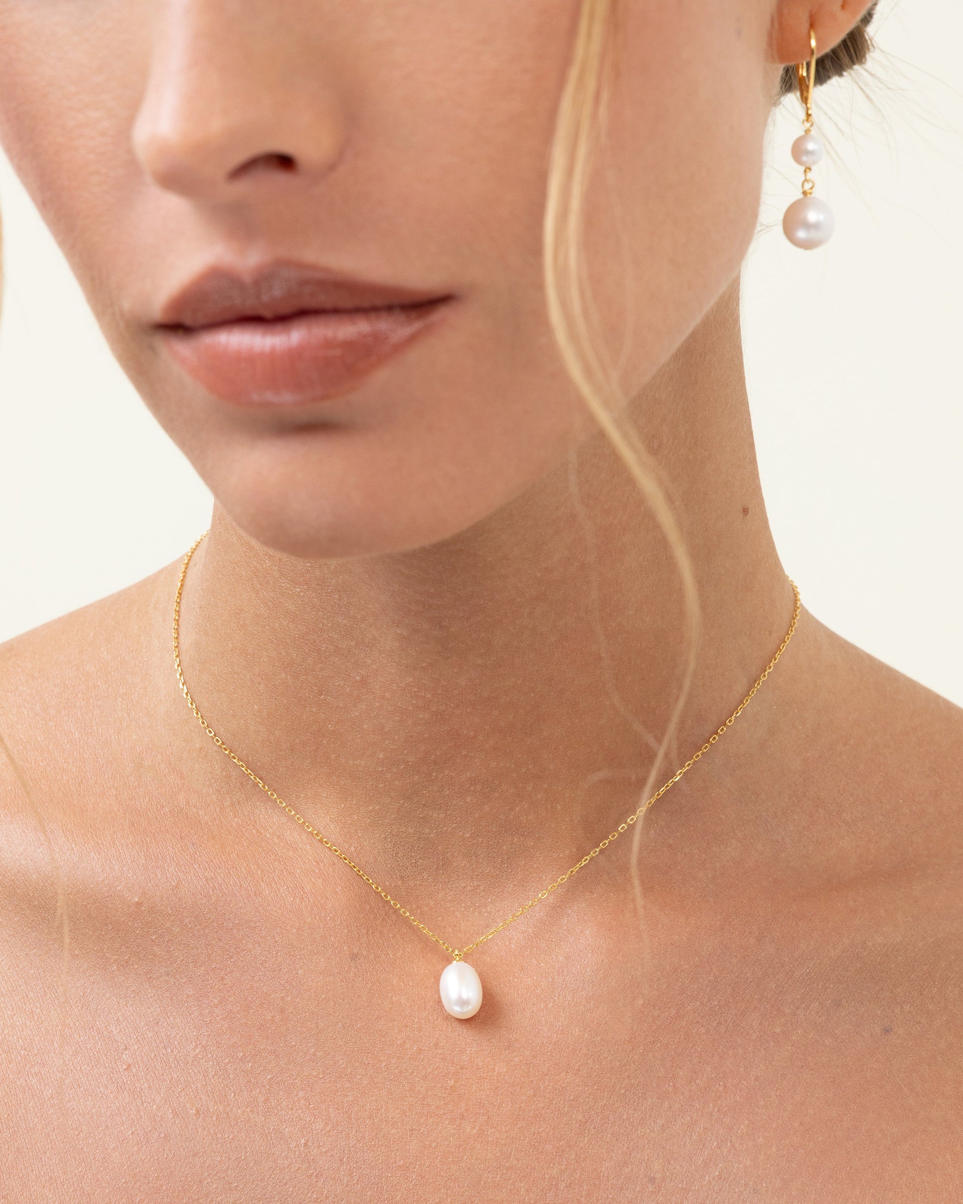 Classic pearl necklace with a large tear shaped pearl, on an adjustable gold chain