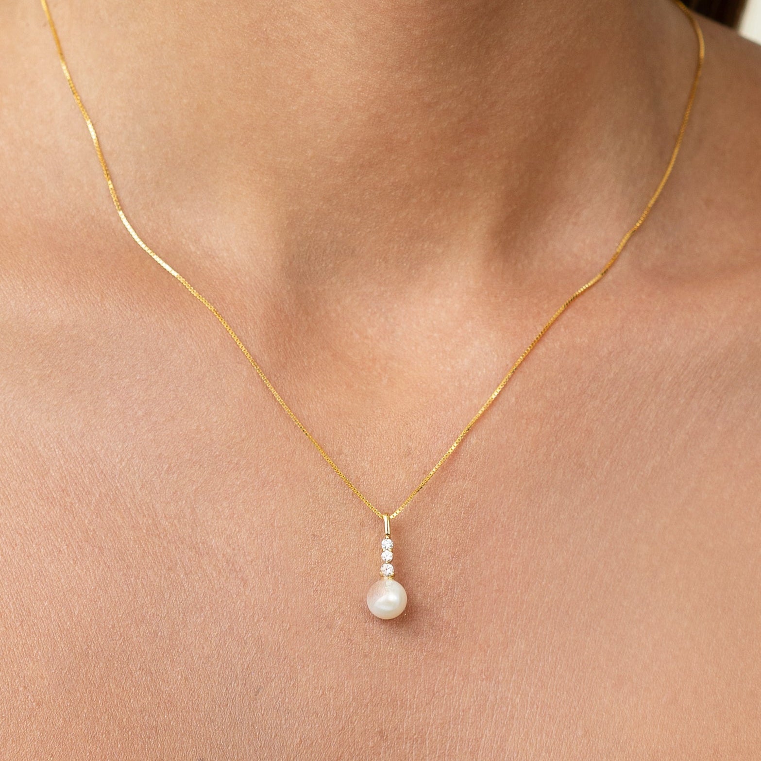 Diamond necklace with 3 diamonds. On a sleek gold adjustable chain, with a beautiful pearl