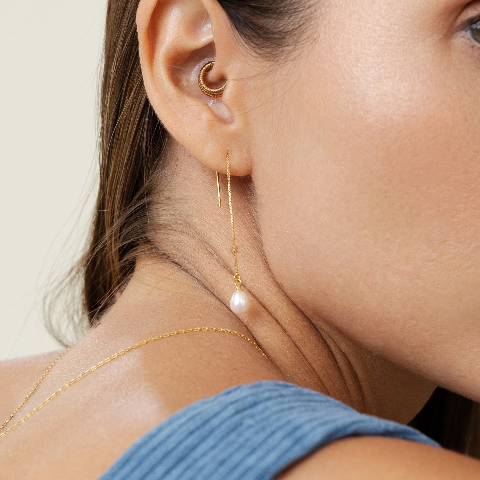Threader earrings featuring teardrop freshwater pearls suspended on delicate 18k gold-plated 925 silver chains