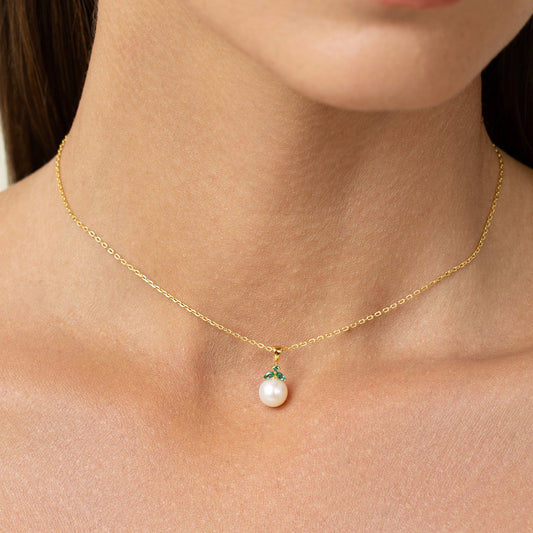 Dainty, cute, emerald pendant. Subtle and trendy pearl jewelry.