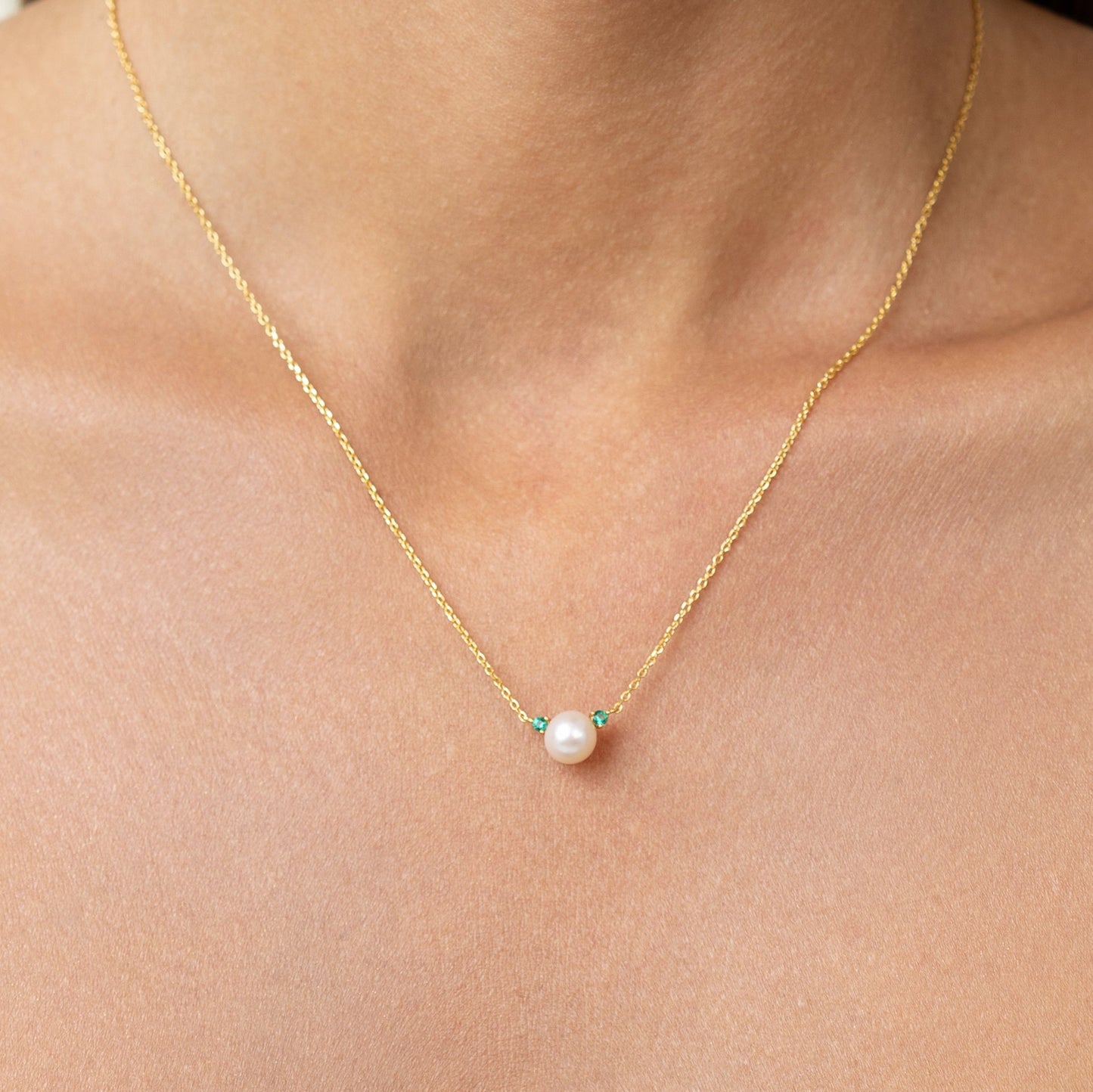 Pearl necklace with lab grown emeralds. on an adjustable gold chain. wear it as a emerald pearl choker