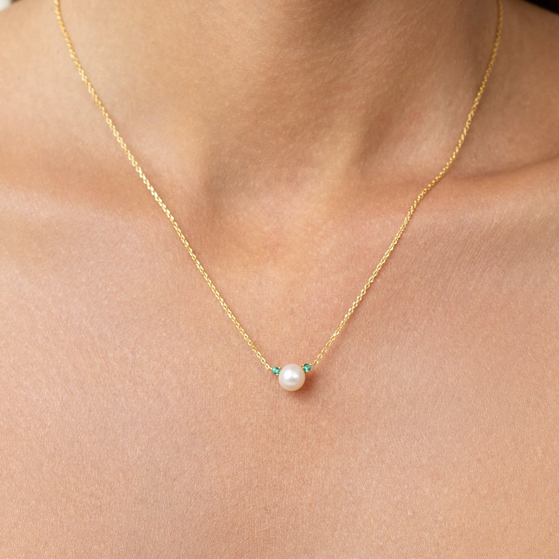 Pearl necklace with lab grown emeralds. on an adjustable gold chain. wear it as a emerald pearl choker