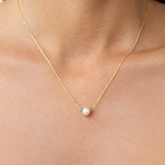 Pearl necklace with lab grown emeralds. on an adjustable gold chain. wear it as a emerald pearl choker