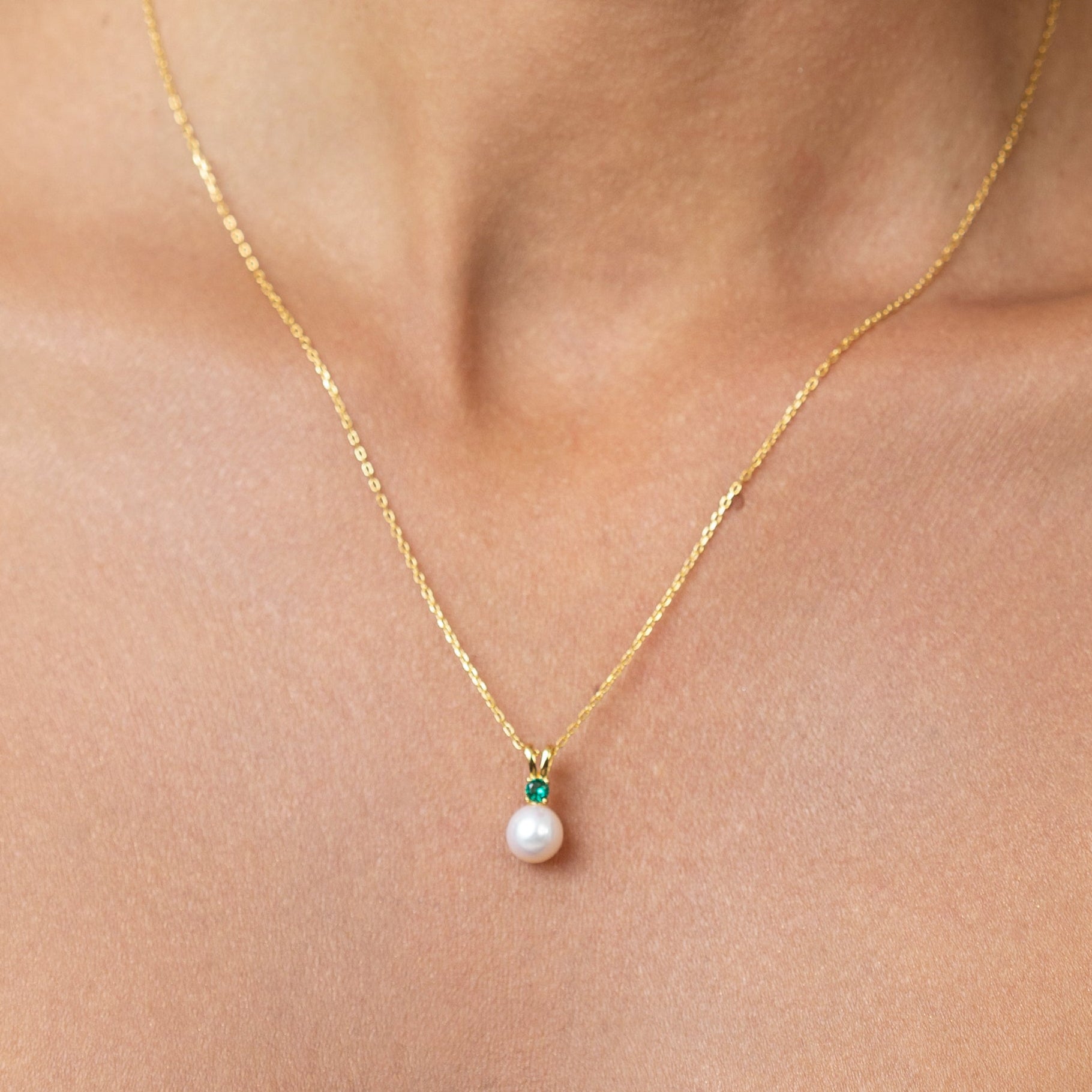 Pearl Pendant with Emerald on a gold adjustable chain.