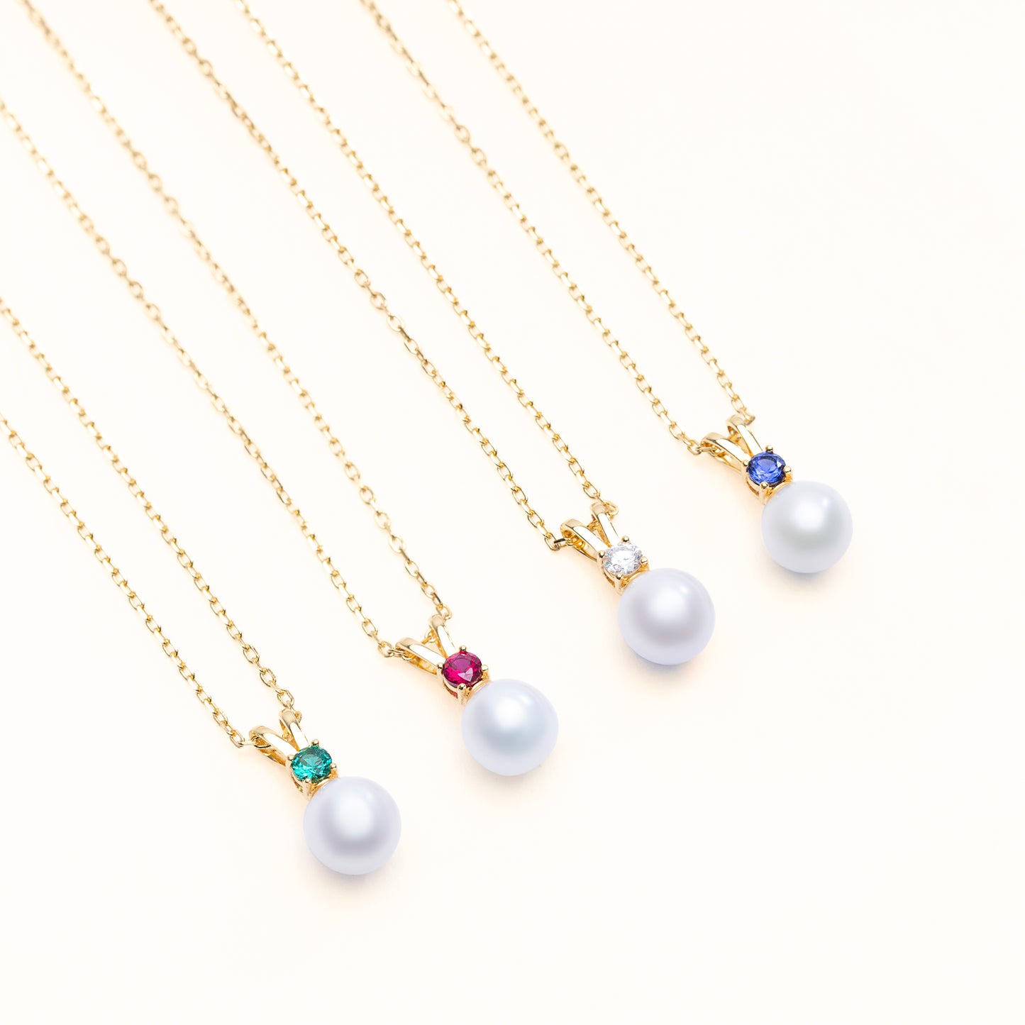 Halo pearl pendant collection with the option of lab grown emerald, ruby, diamond, sapphire