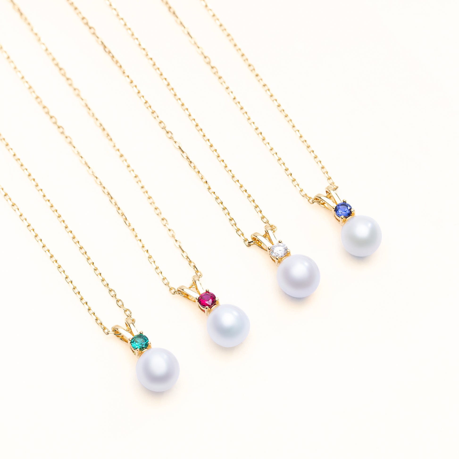 Halo pearl pendant collection with the option of lab grown emerald, ruby, diamond, sapphire