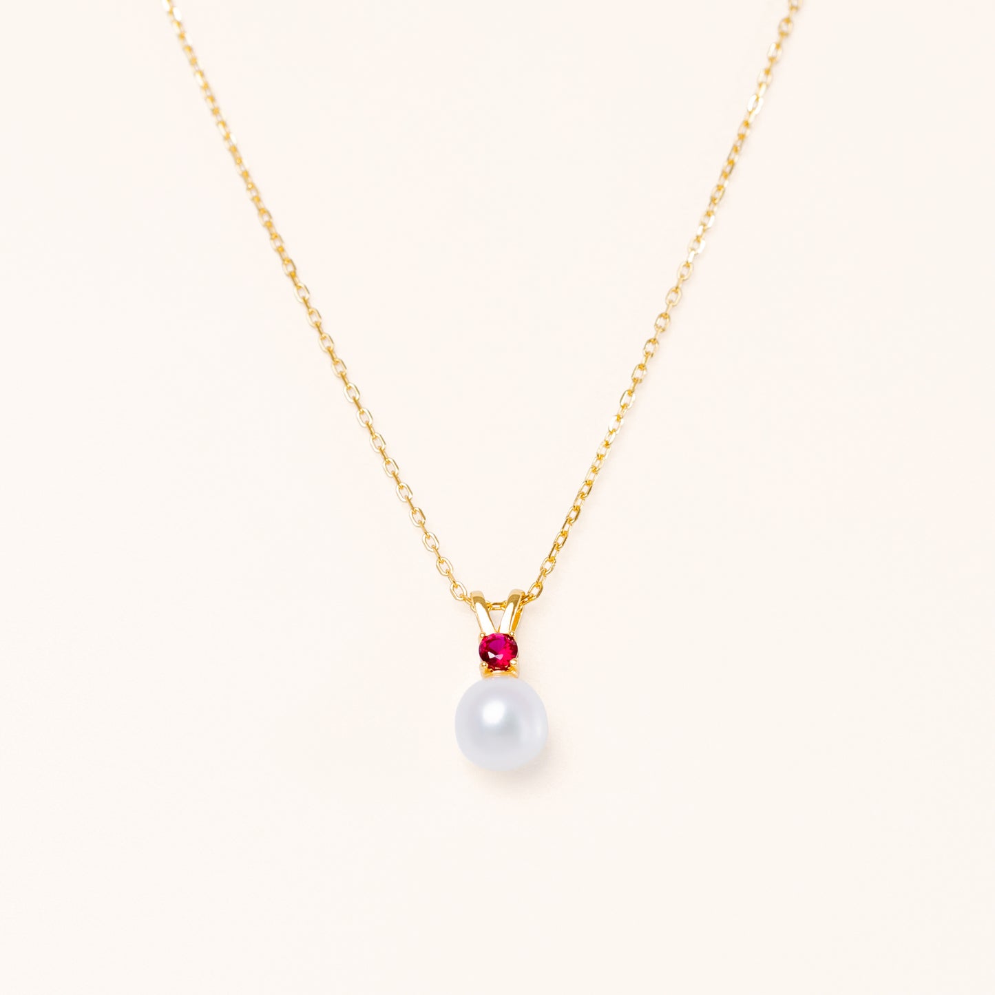 Pearl pendant with a red ruby. Gold plated silver for beautiful quality.
