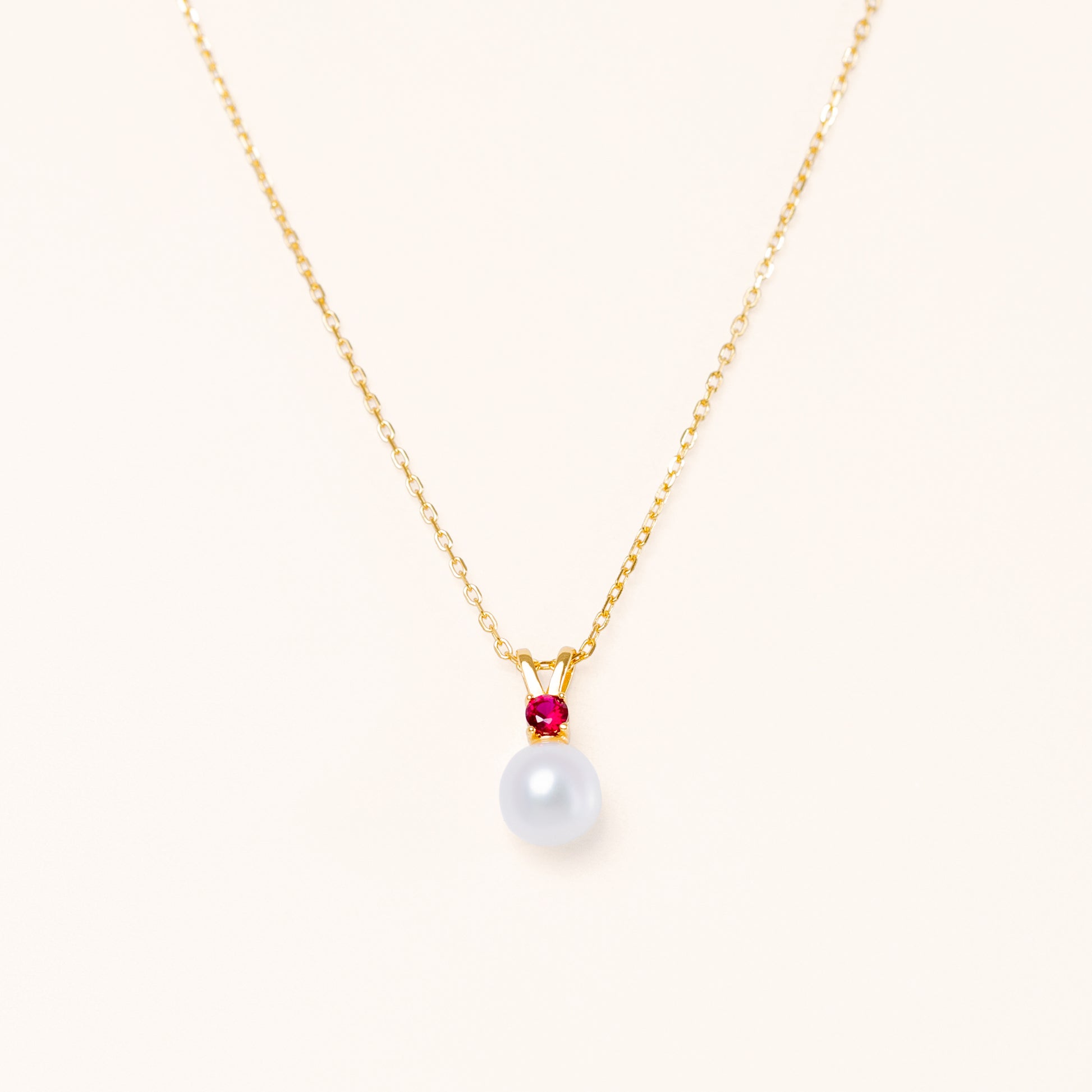 Pearl pendant with a red ruby. Gold plated silver for beautiful quality.