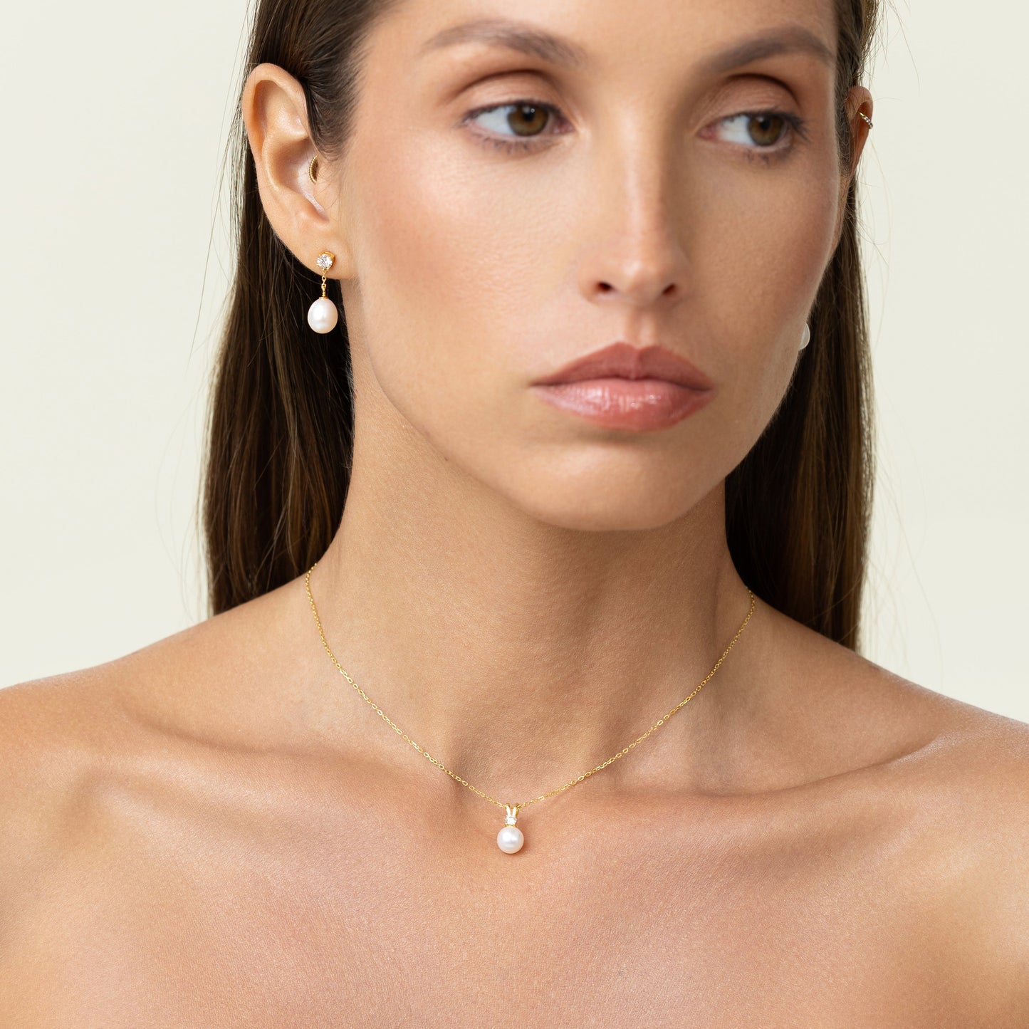 Pearl pendant with a large diamond and an adjustable gold chain.