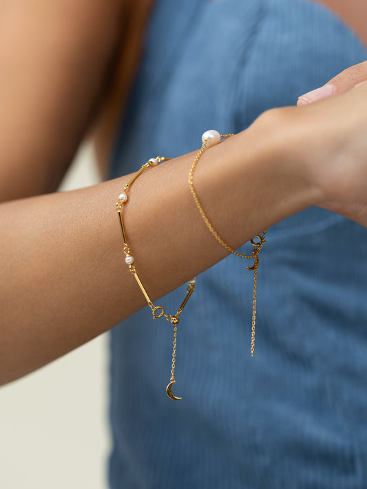 The golden bar bracelet comes with beautiful pearls and an adjustable clasp