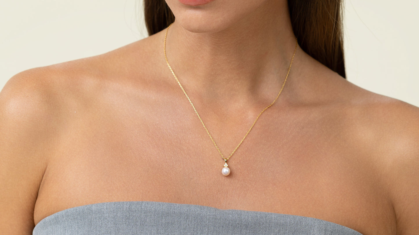 Pearl pendant with 3 lab grown diamonds. On a gold chain