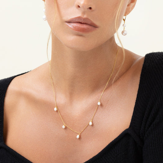 Pearl drop necklace with 5 dangling pearls from a gold chain. Adjustable, can be worn as a choker