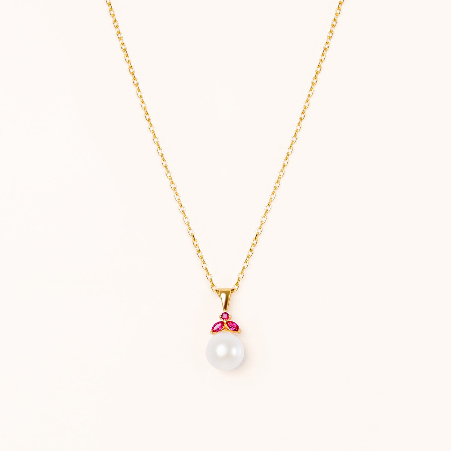 Pearl pendant with red rubies. Shaped like a beautiful fruit