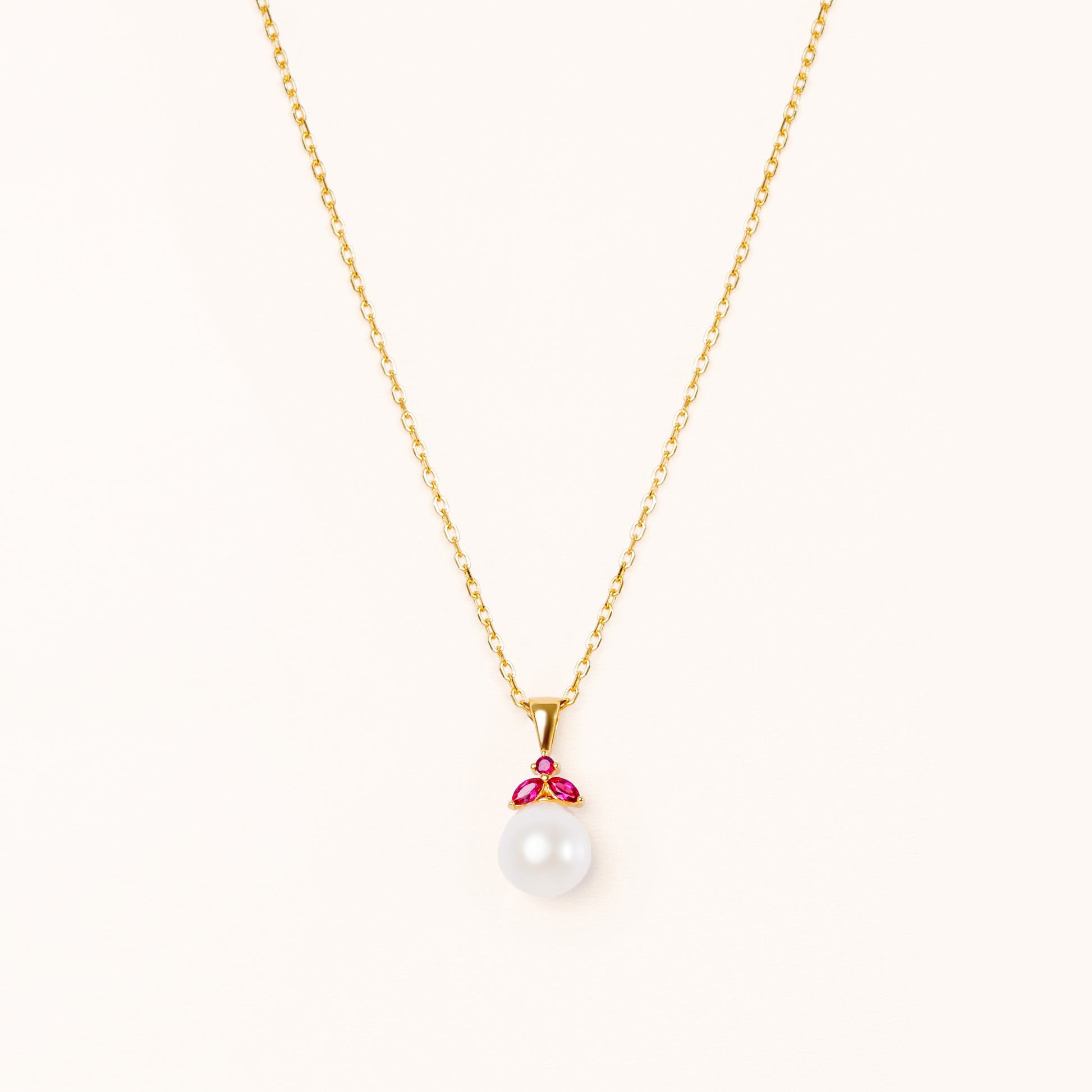 Pearl pendant with red rubies. Shaped like a beautiful fruit