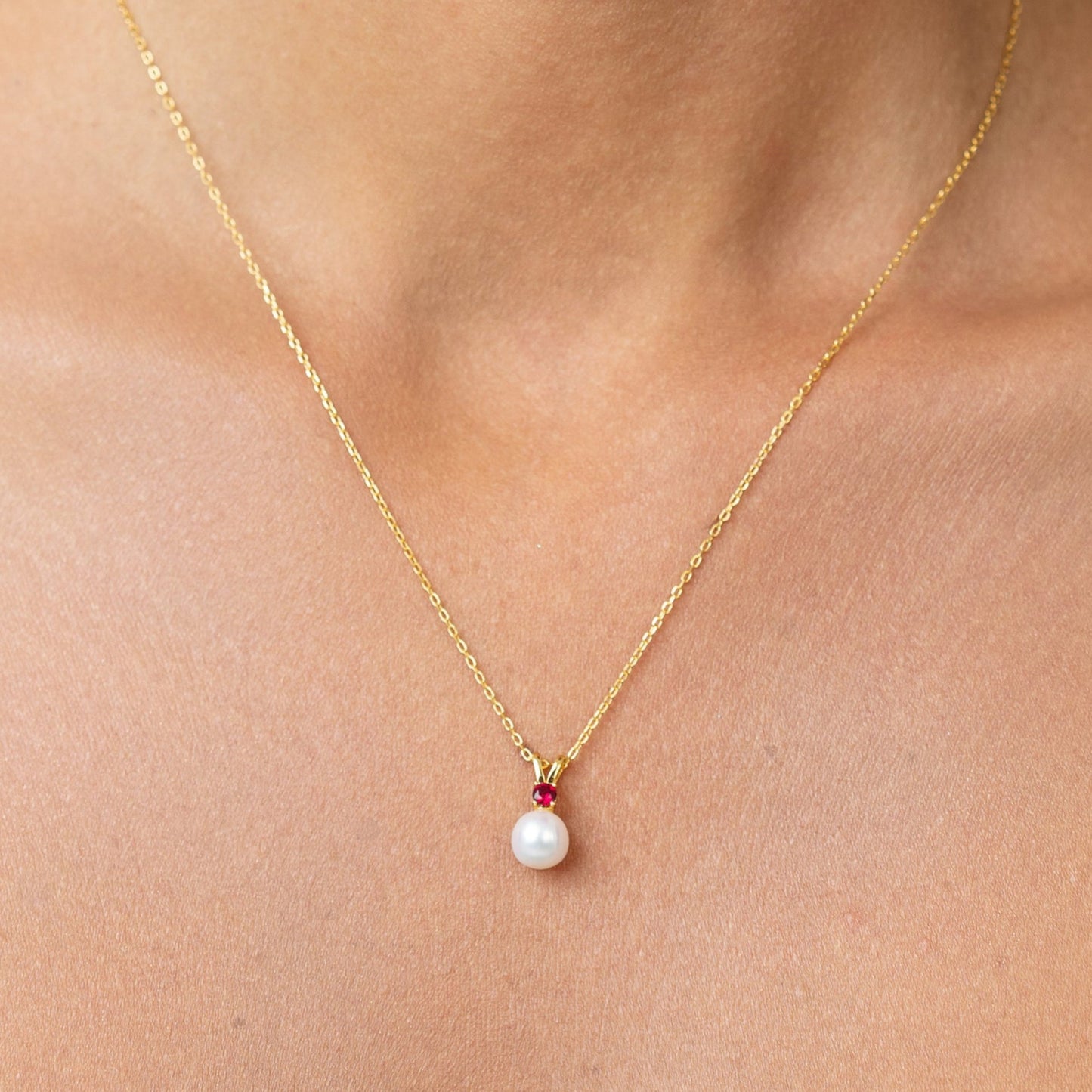 Beautiful vibrant red ruby on a pendant. With a golden adjustable chain