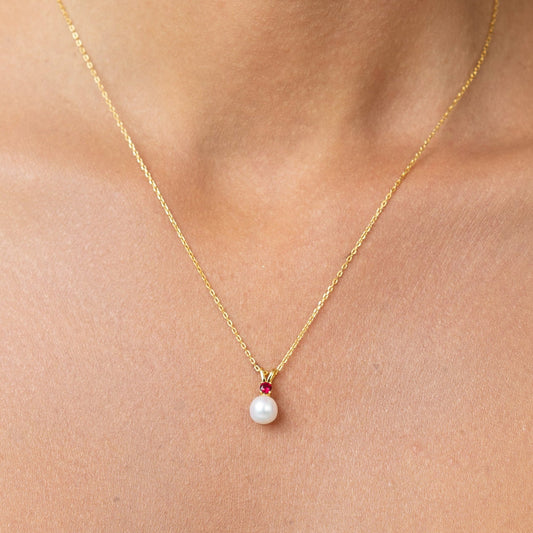 Beautiful vibrant red ruby on a pendant. With a golden adjustable chain