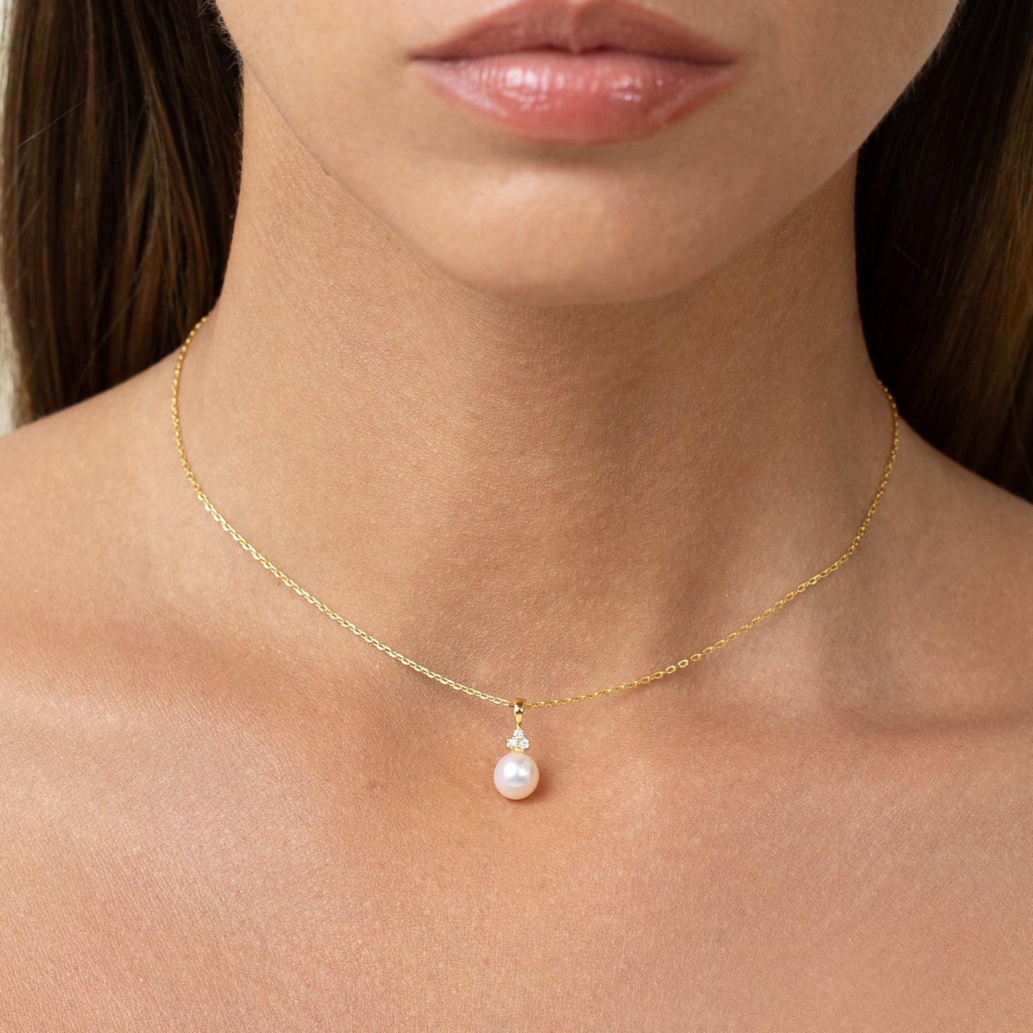 Pearl pendant with 3 lab grown diamonds. On a gold chain
