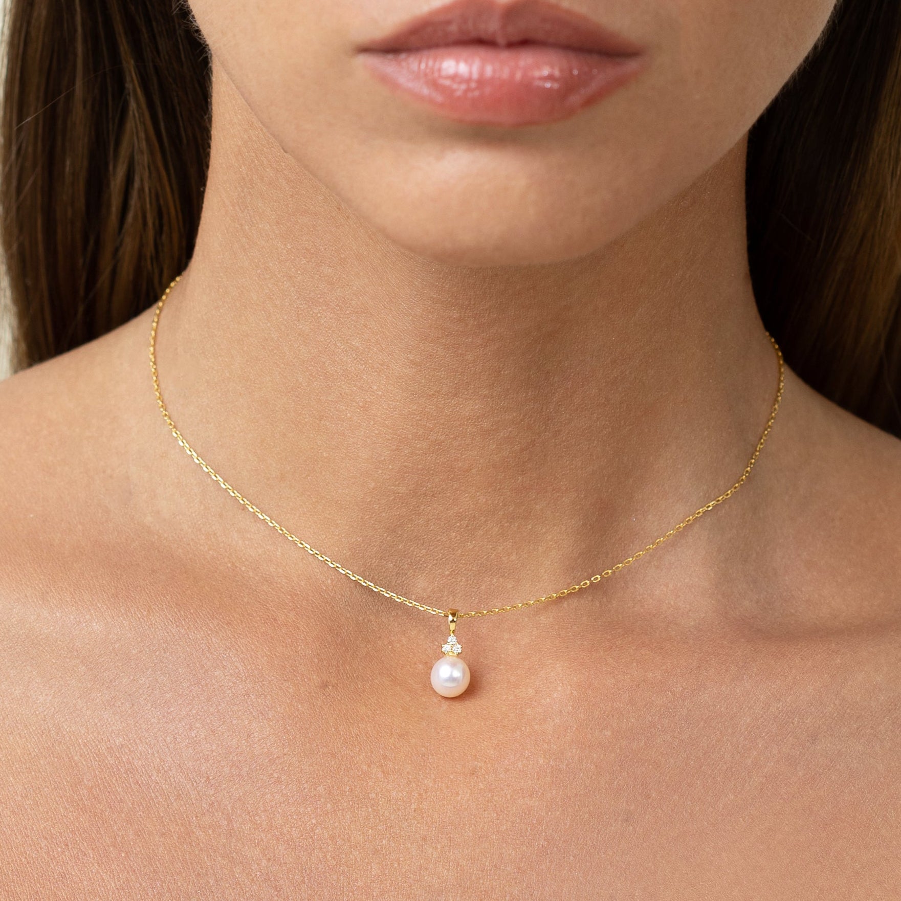 Pearl pendant with 3 lab grown diamonds. On a gold chain