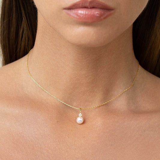 Pearl pendant with 3 lab grown diamonds. On a gold chain