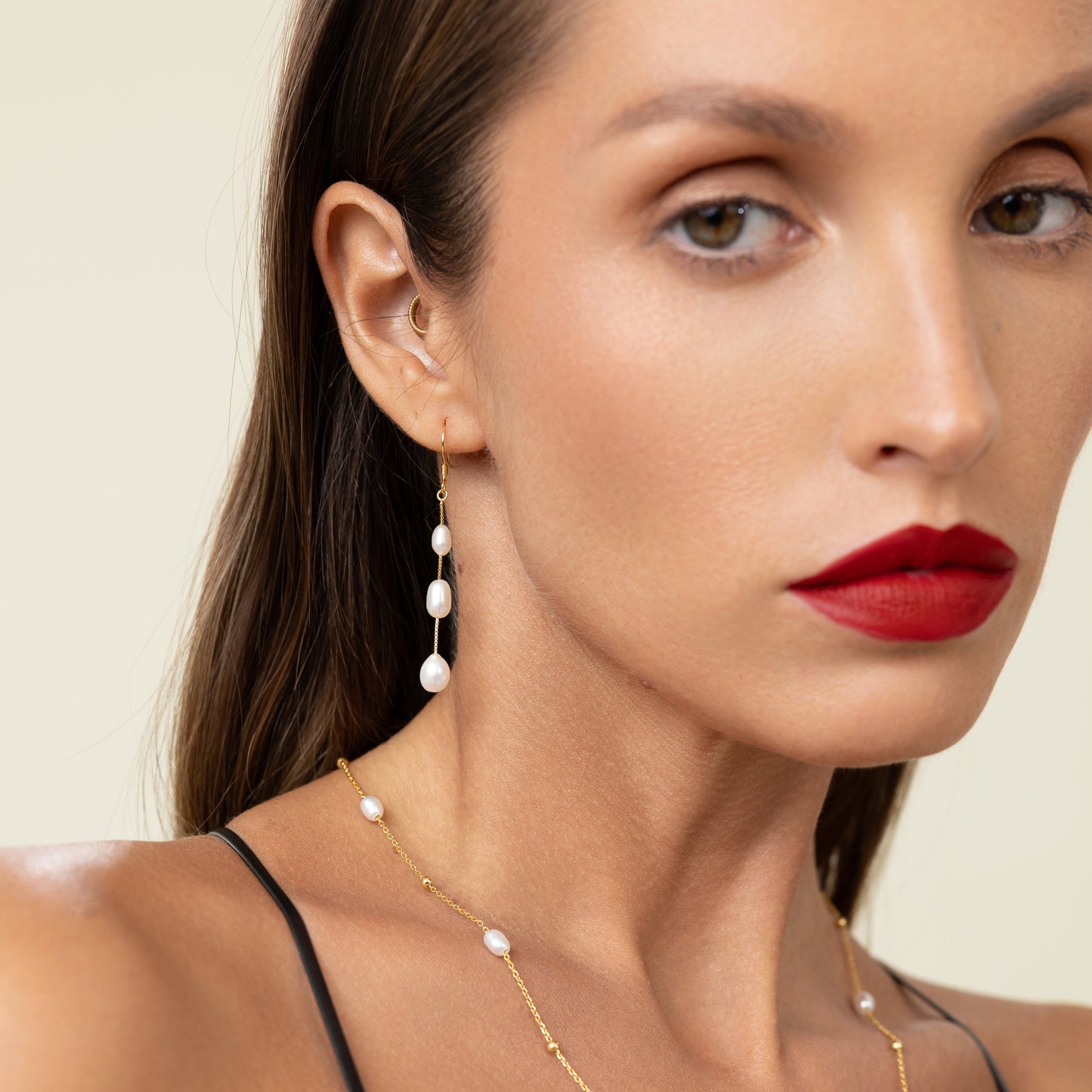 Long drop earrings featuring three oval freshwater pearls on delicate 18k gold-plated 925 silver hook wires