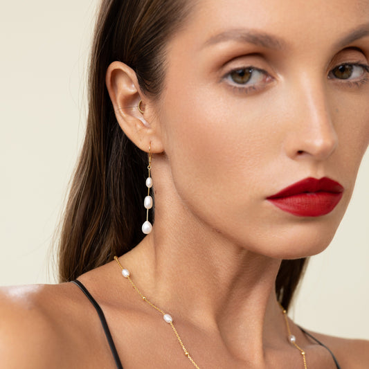 Long drop earrings featuring three oval freshwater pearls on delicate 18k gold-plated 925 silver hook wires