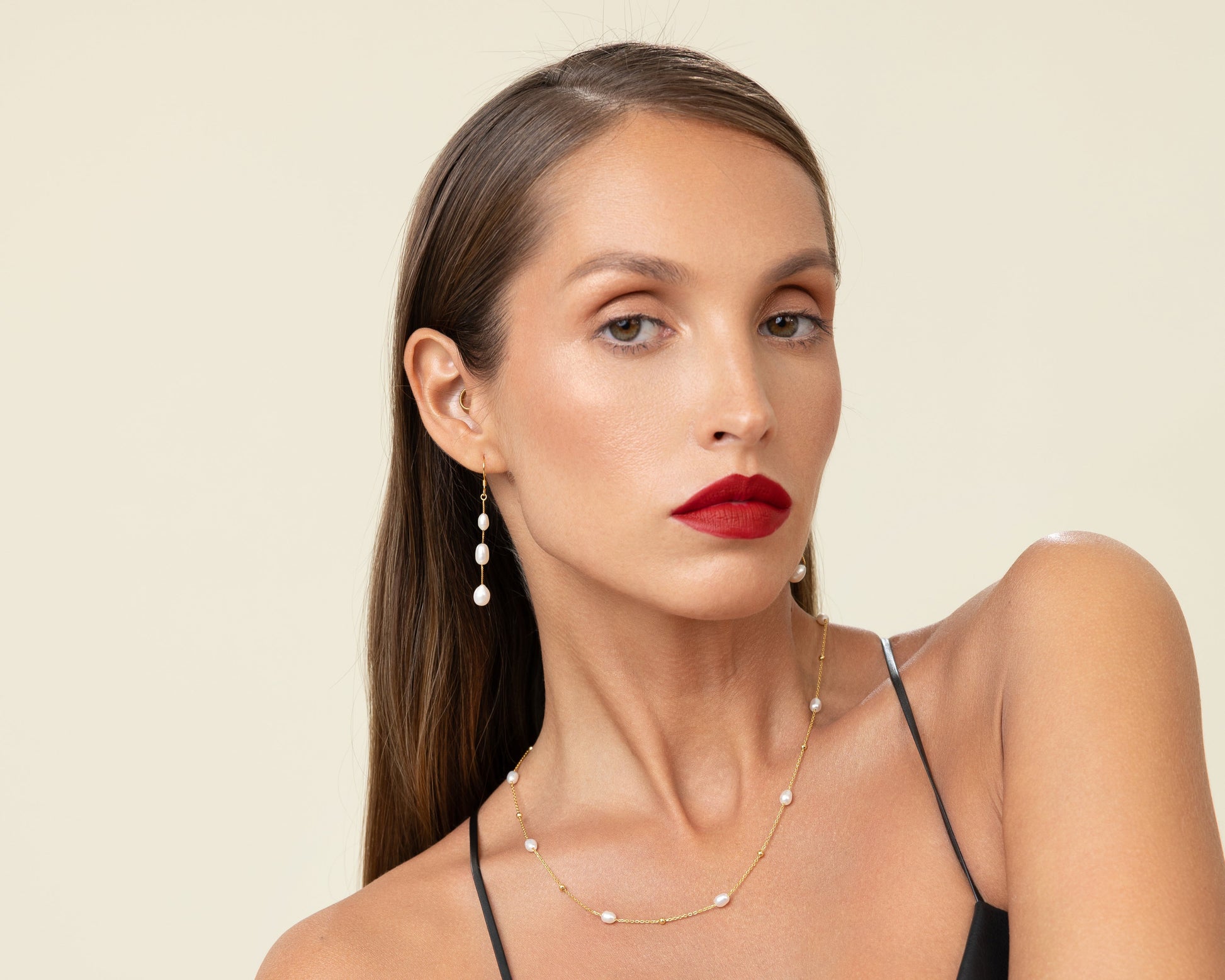 Long drop earrings featuring three oval freshwater pearls on delicate 18k gold-plated 925 silver hook wires