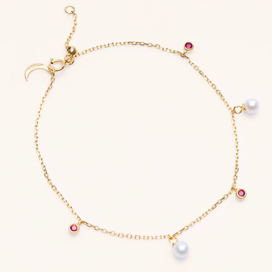 Pearl Luna Bracelet with an adjustable sliding clasp. With small round pearls and ruby charms