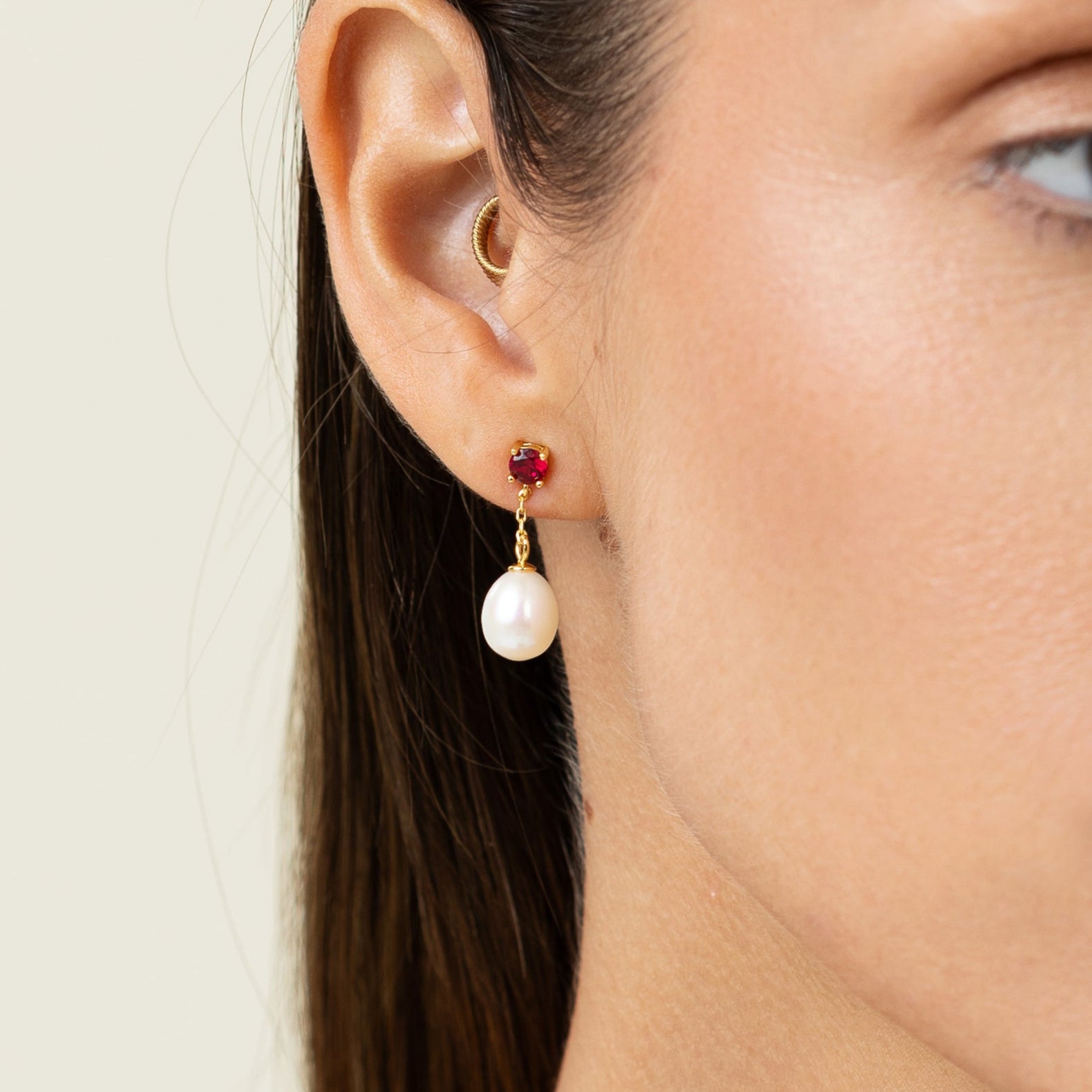 Drop earring featuring a round lab-grown ruby stud and an oval freshwater pearl on 18k gold-plated 925 silver