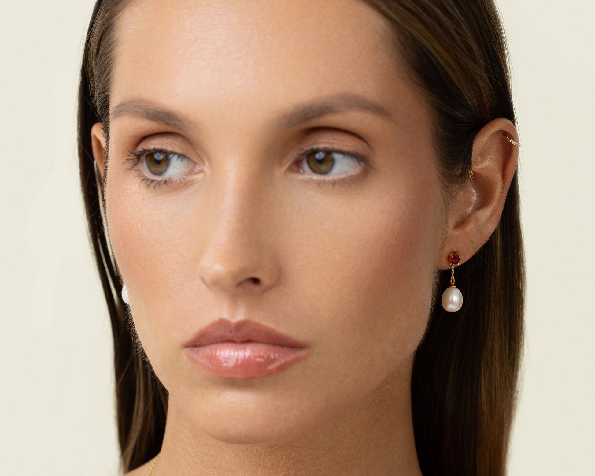 Drop earring featuring a round lab-grown ruby stud and an oval freshwater pearl on 18k gold-plated 925 silver