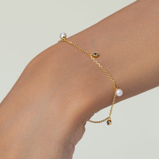 Pearl bracelet on a gold chain with dainty sapphire charms