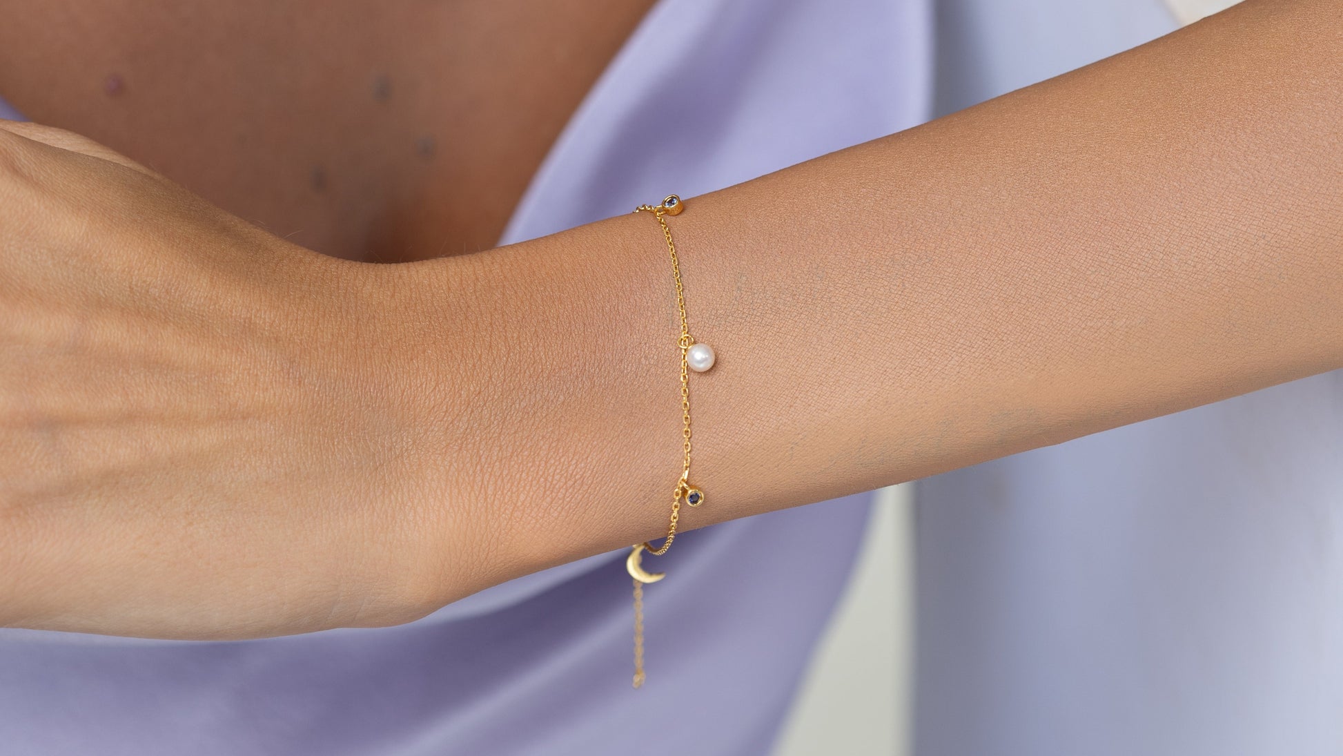 Pearl bracelet on a gold chain with dainty blue sapphire charms