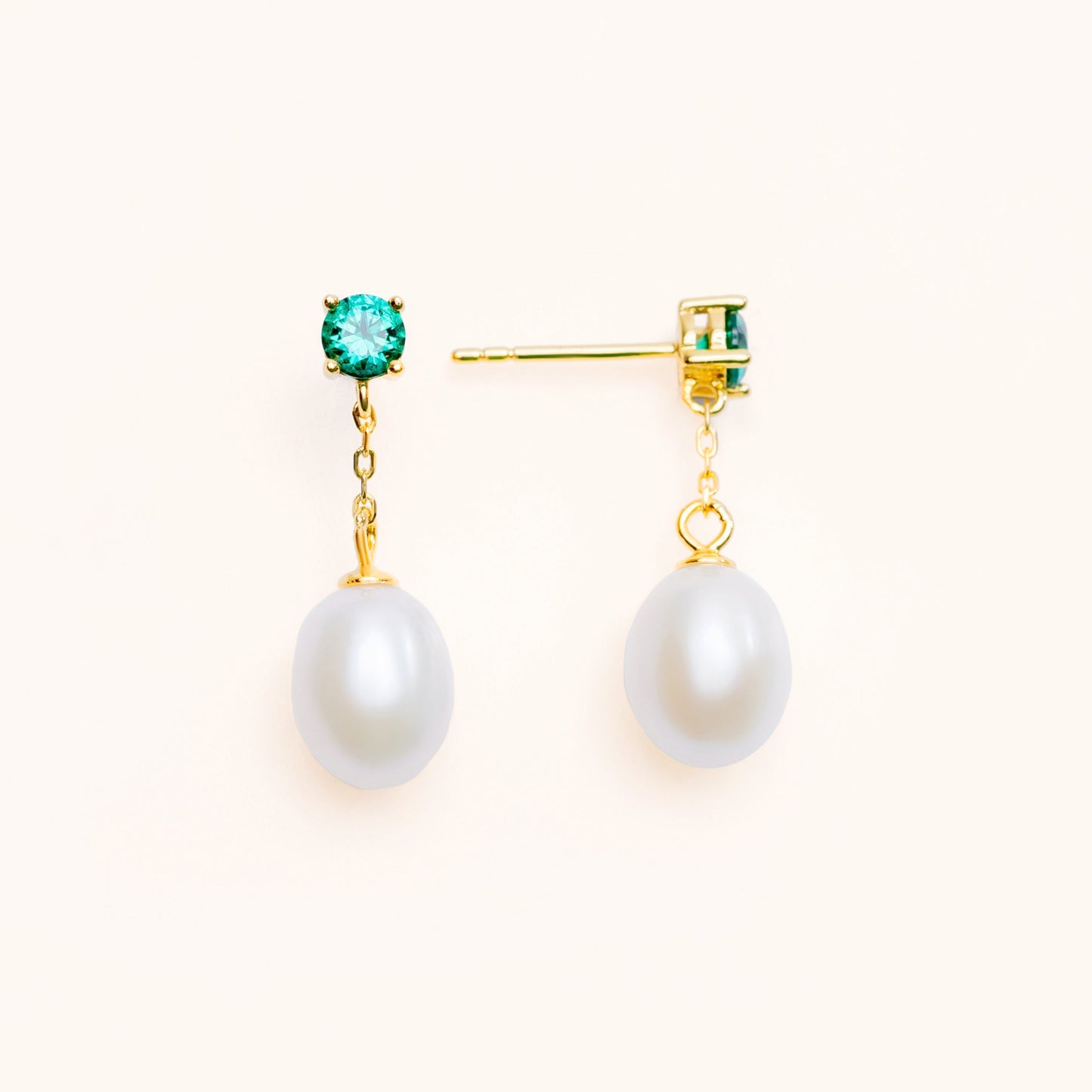 Beautiful pearls dangling from a large green emerald