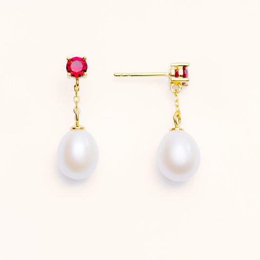 Beautiful pearls dangling from a large red ruby