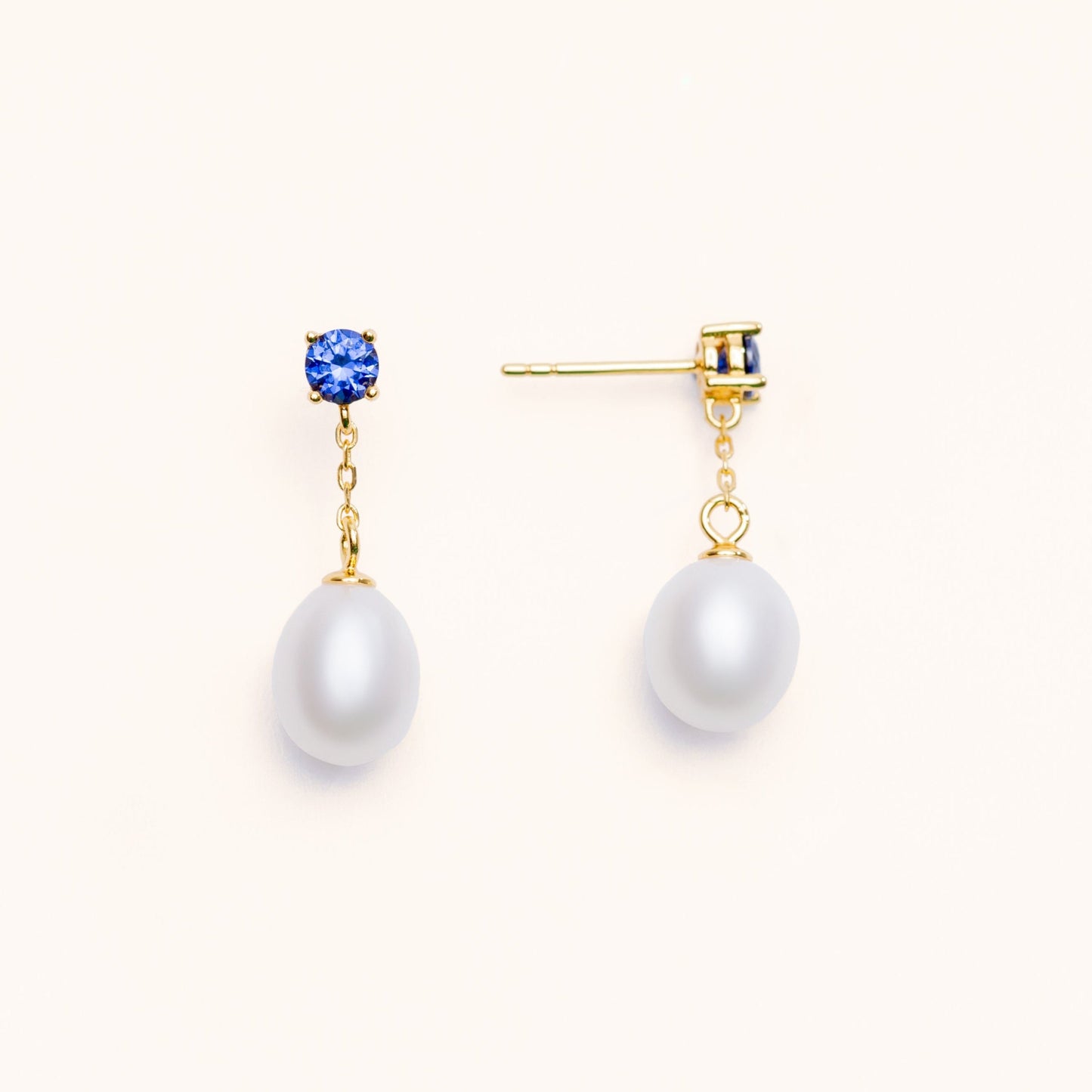 Beautiful pearls dangling from a large blue sapphire