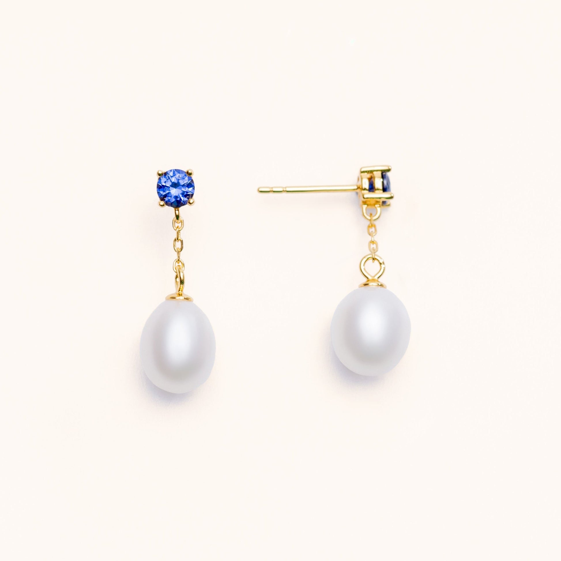 Beautiful pearls dangling from a large blue sapphire