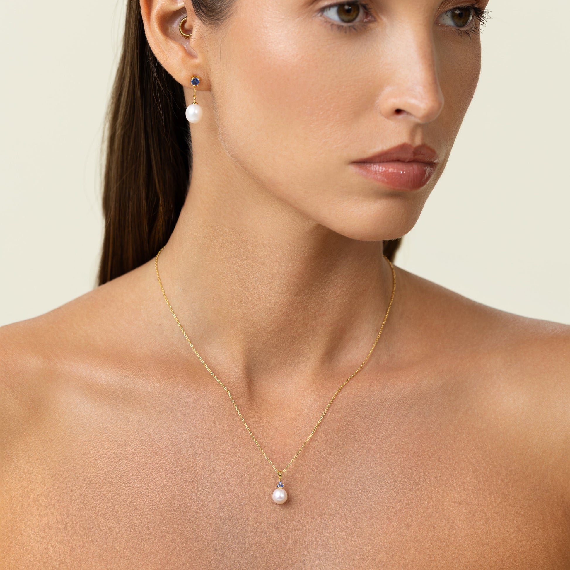 Pearl pendant with 3 sapphires on an adjustable gold chain.