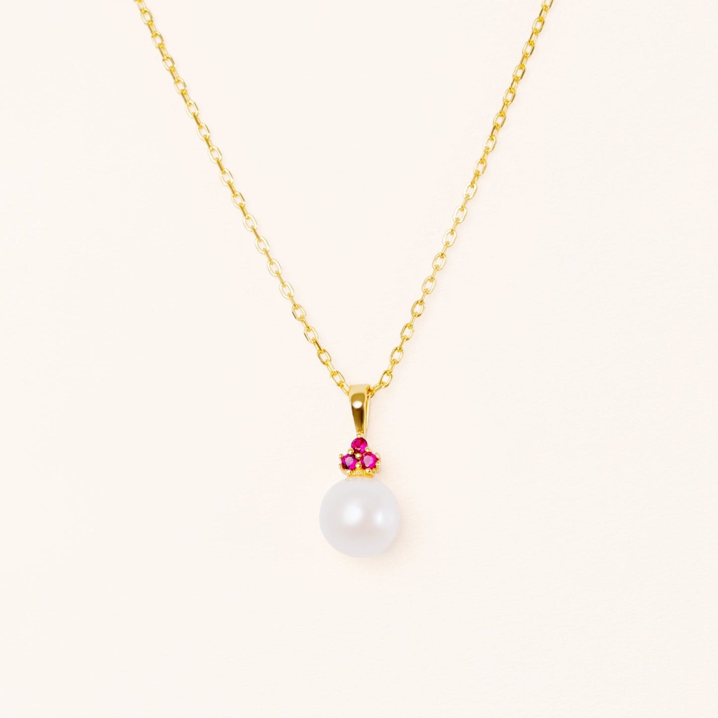 Pearl pendant with three beautiful red rubies. On an adjustable gold chain