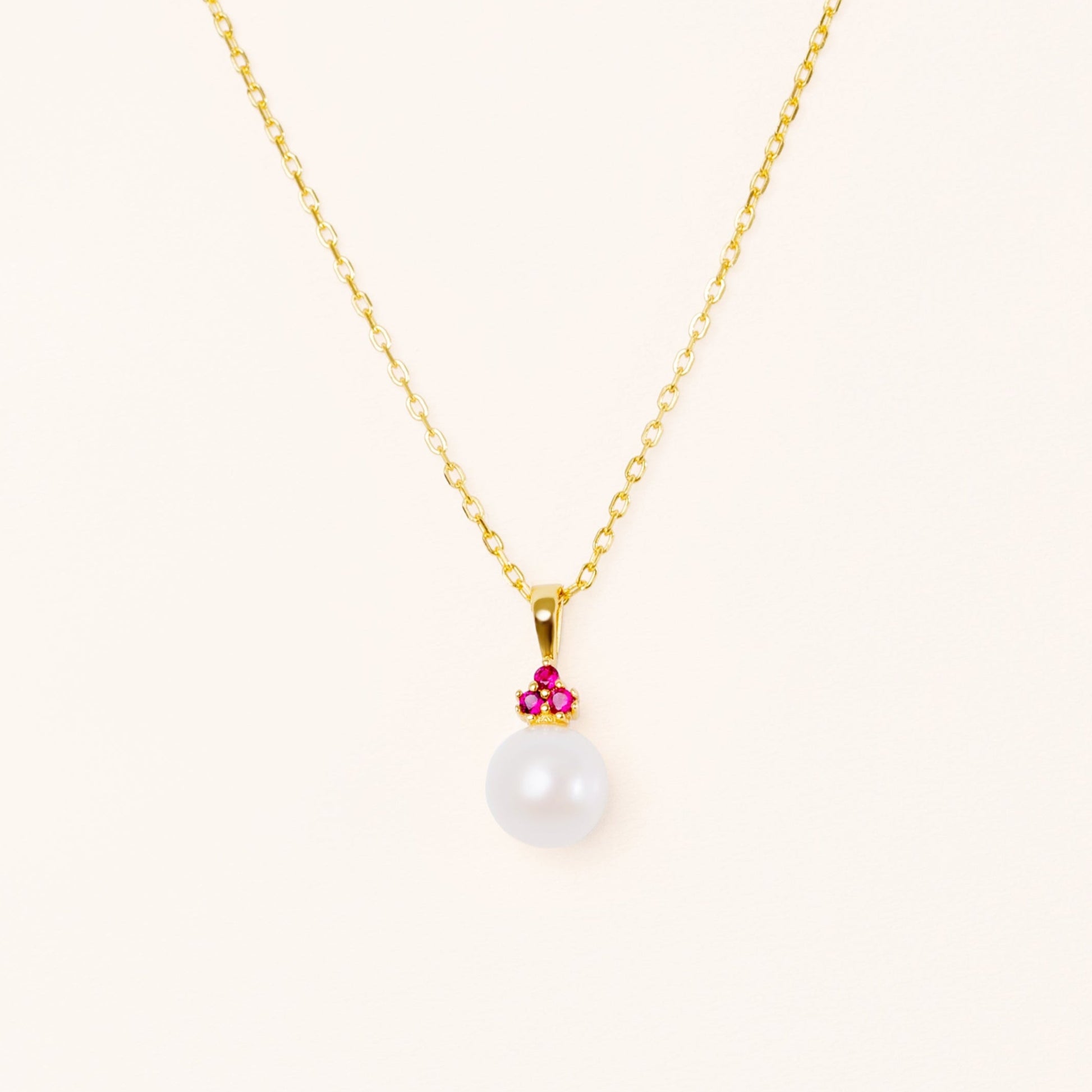 Pearl pendant with three beautiful red rubies. On an adjustable gold chain