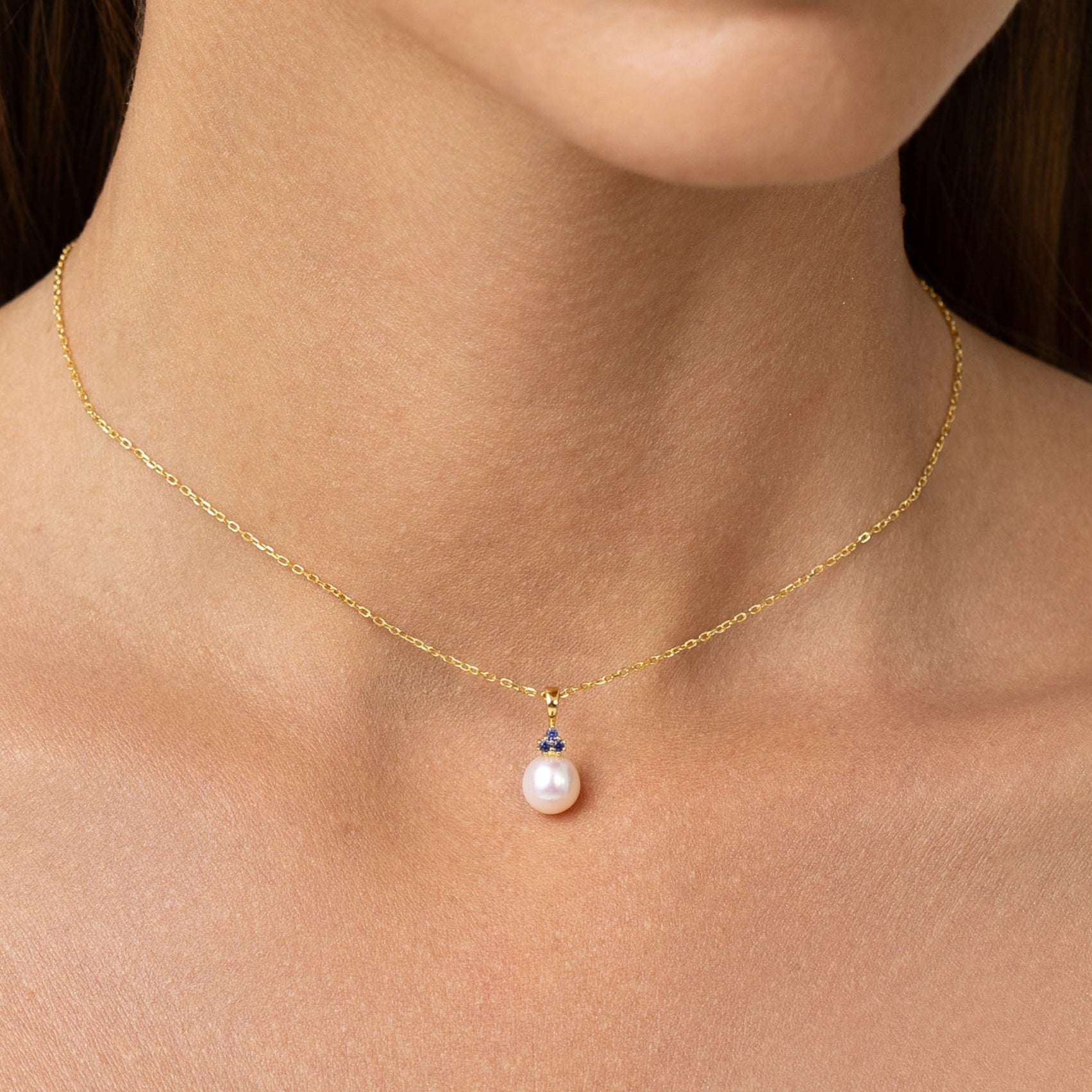Pearl pendant with 3 sapphires on an adjustable gold chain.