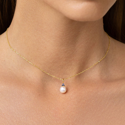 Pearl pendant with 3 sapphires on an adjustable gold chain.
